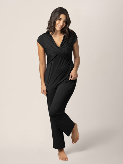 Model wearing the Davy Maternity & Nursing Pajama Set in Black, standing on one leg @model_info:Alexis is 5'10" and wearing a Medium.