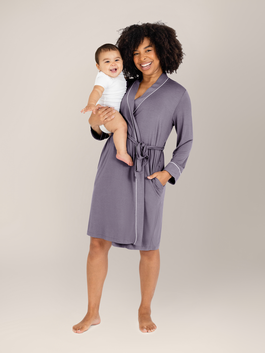 Model with her baby on her hip wearing the Clea Bamboo Robe in Granite. @model_info:Tess is 5'5" and wearing a S/M.