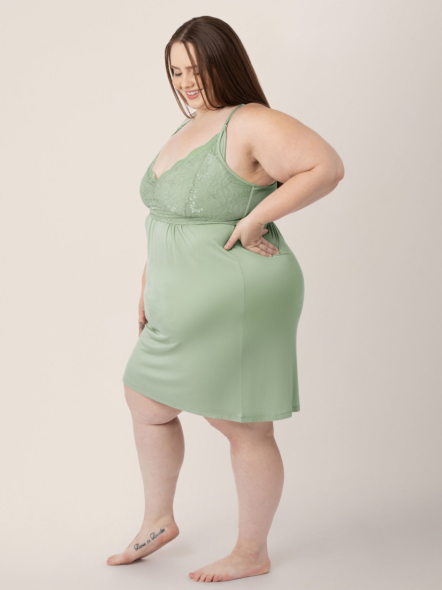 Side view of a model wearing the Lucille Maternity & Nursing Nightgown in Pistachio.
