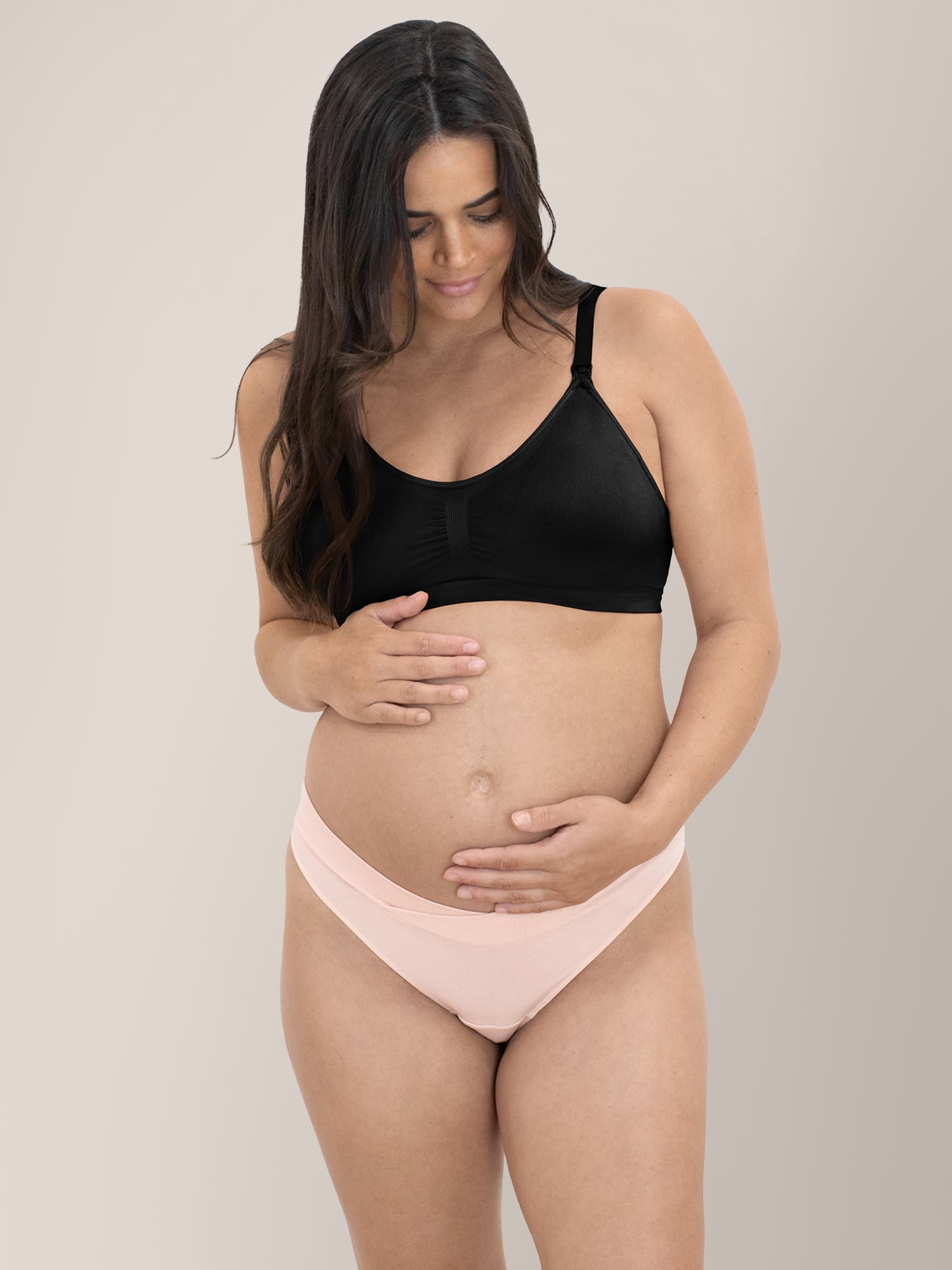 Front view of a pregnant model wearing the Bamboo Maternity & Postpartum Thong in Soft Pink 