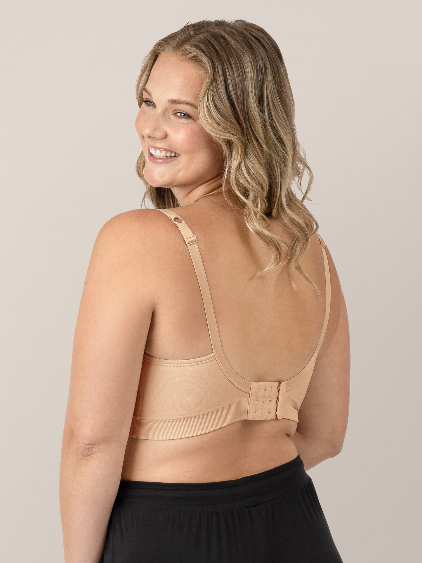 Back view of a model wearing the Everly Wireless Contour Bra in Beige.