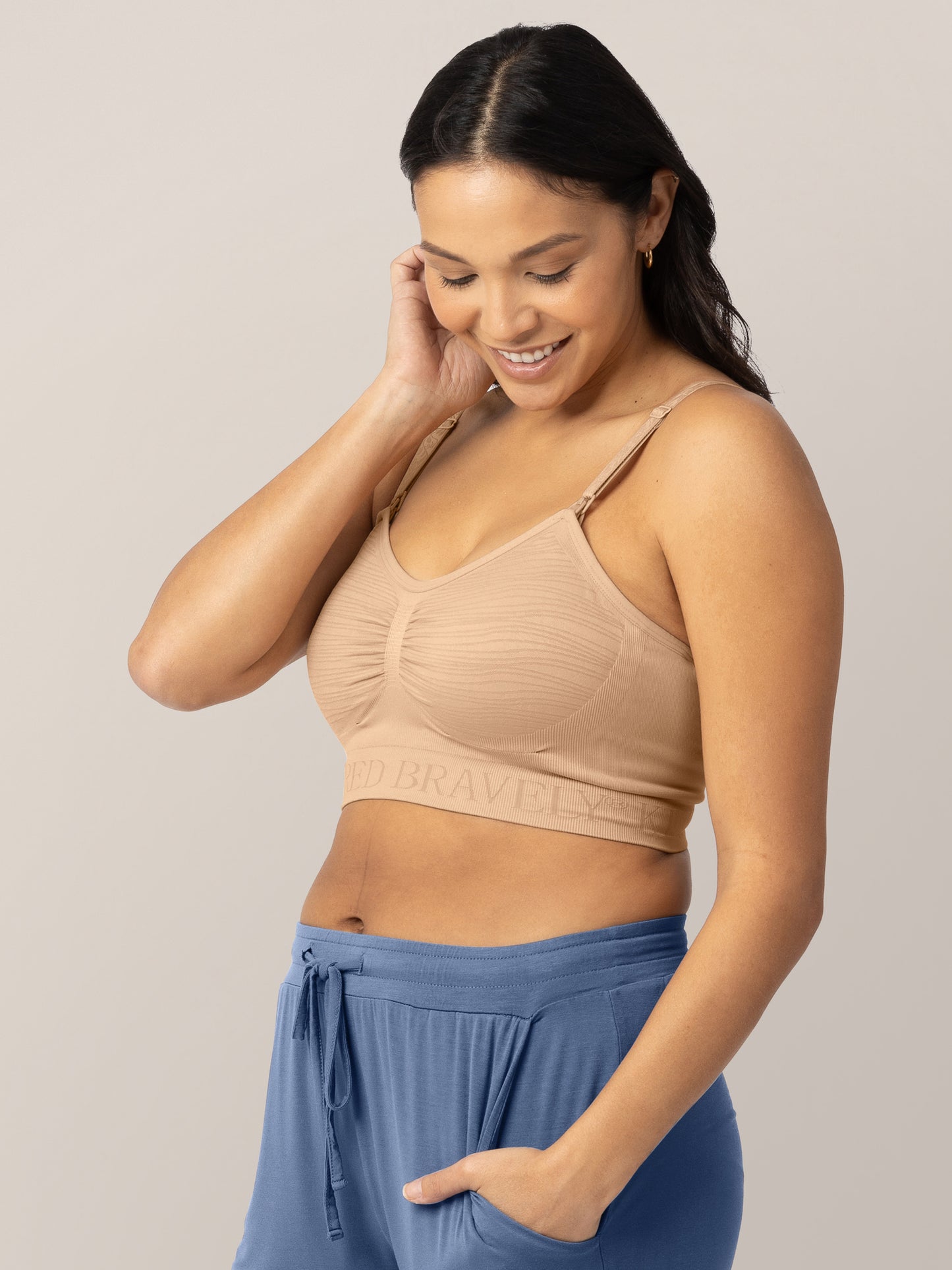 Model wearing the Sublime® Hands-Free Pumping & Nursing Bra in Beige looking down