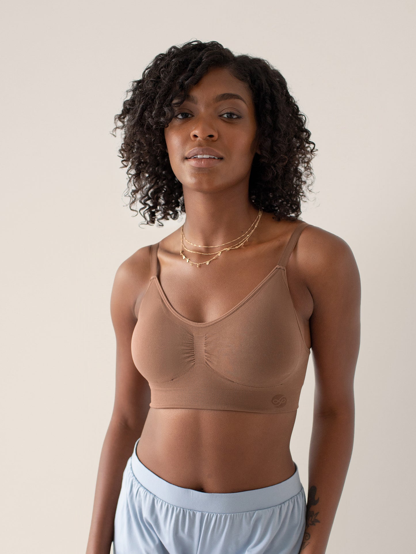 Model standing up wearing the Nellie Sublime® Wireless Bra in Mocha