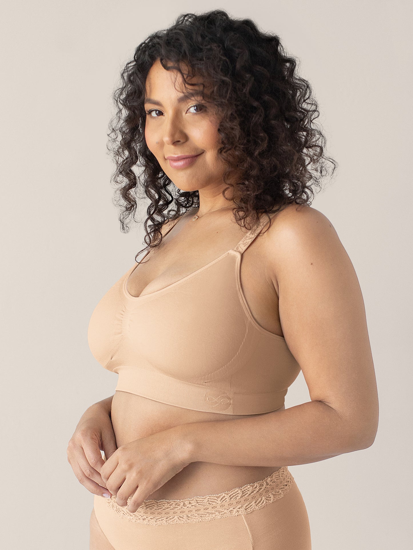 Model wearing the Nellie Sublime® Wireless Bra in Beige with her hands near her stomach.