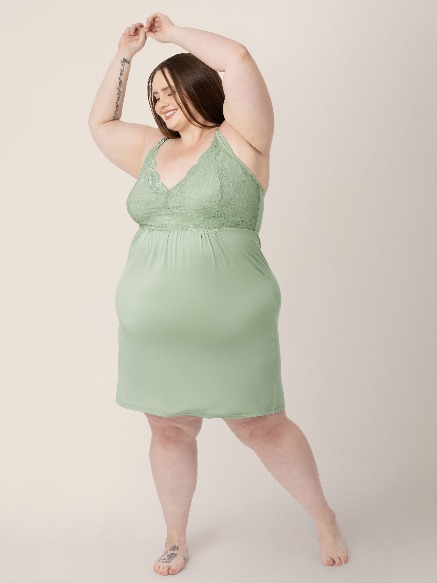 Model with her hands above her head wearing the Lucille Maternity & Nursing Nightgown in Pistachio.