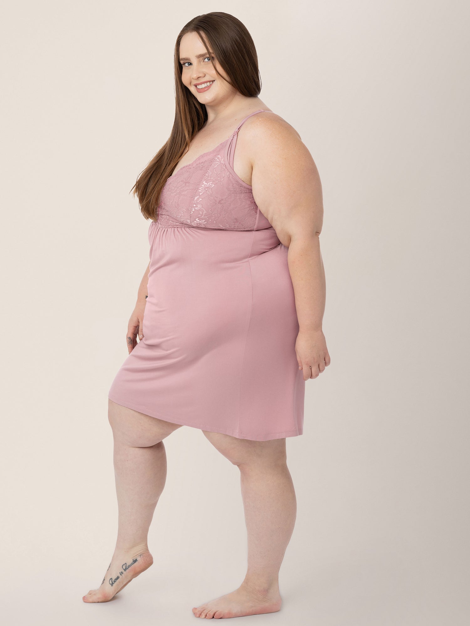 Three quarters view of a model wearing the Lucille Maternity & Nursing Nightgown in Vintage Pink.