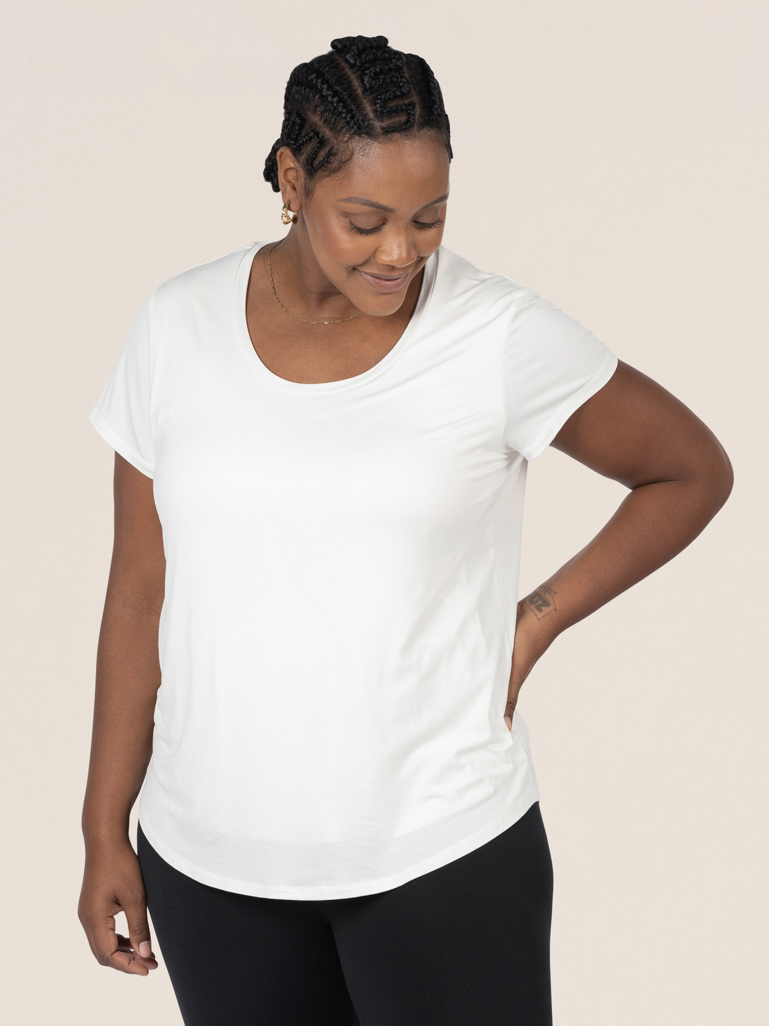 Model wearing the Everyday Maternity & Nursing T-shirt in White  with her hand on her hip. @model_info:Roxanne is wearing a Large.