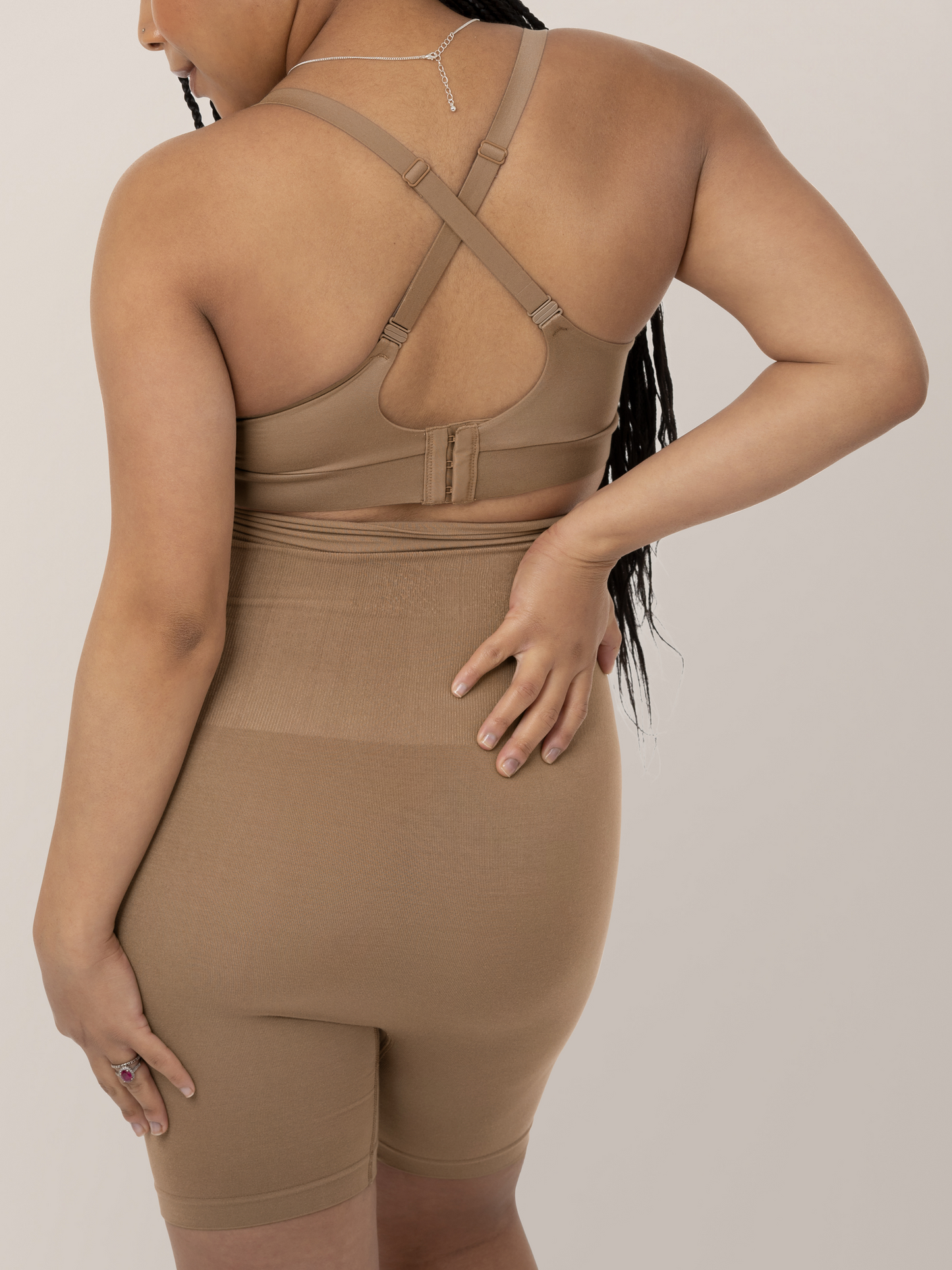 Back of a model wearing the Minimalist Hands-Free Pumping and Nursing Bra in Latte. 