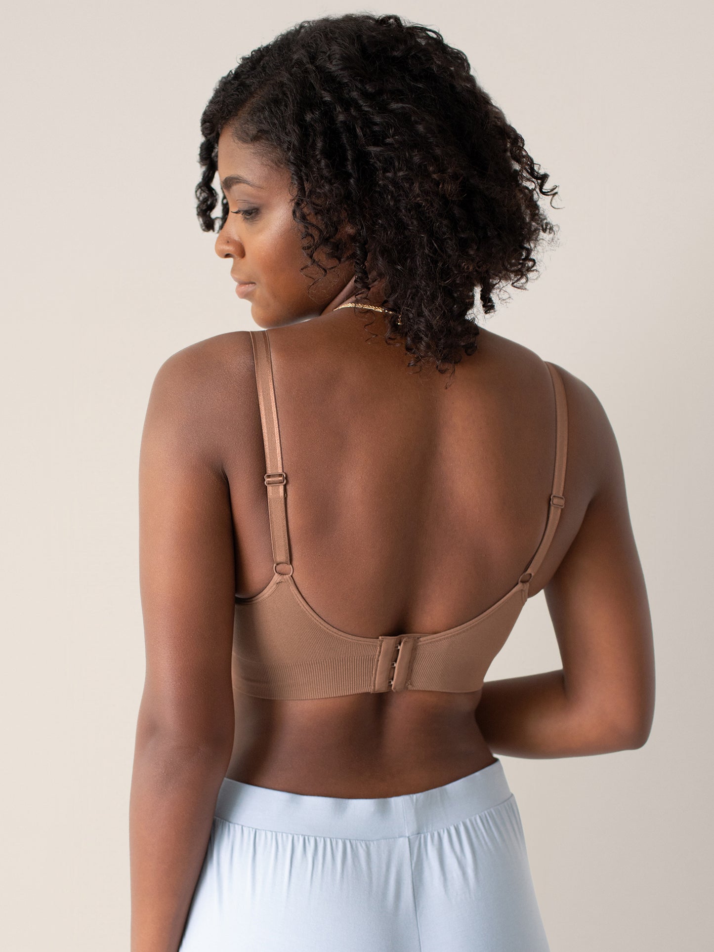 Back view of a model wearing the Nellie Sublime® Wireless Bra in Mocha