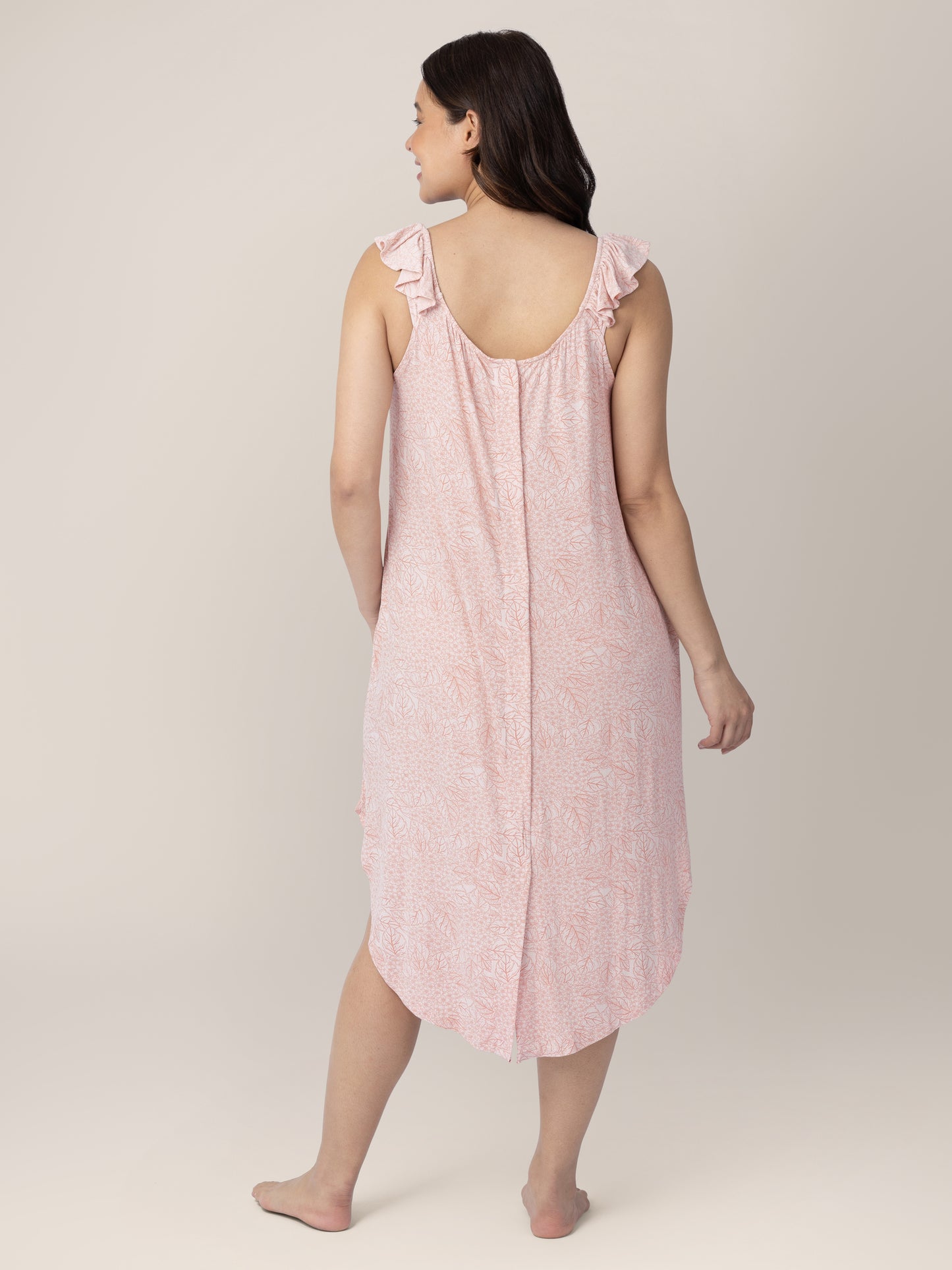 Back of a pregnant model wearing the Ruffle Strap Labor & Delivery Gown in Pink Hydrangea.