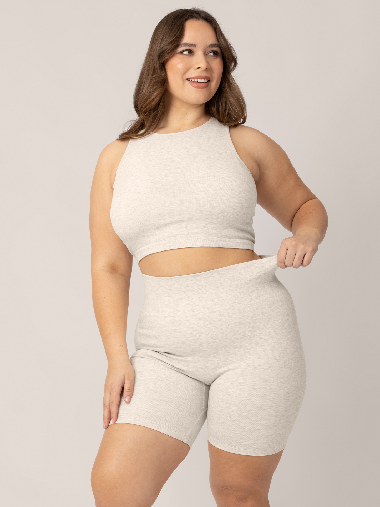 Front view of a model wearing the Sublime® Bamboo Maternity & Postpartum Bike Short in Oatmeal Heather, paired with matching Sublime® Bamboo Maternity & Nursing Longline Bra. @model_info:Venezia is 5’6" and wearing a 1X.