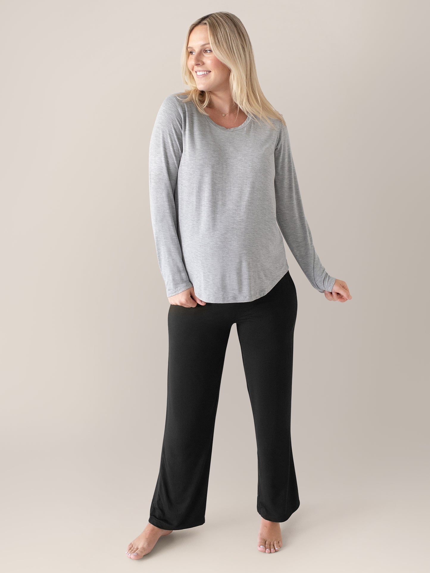 Model wearing the  Bamboo Maternity & Nursing Long Sleeve T-shirt in Grey Heather with her hand on the hem.