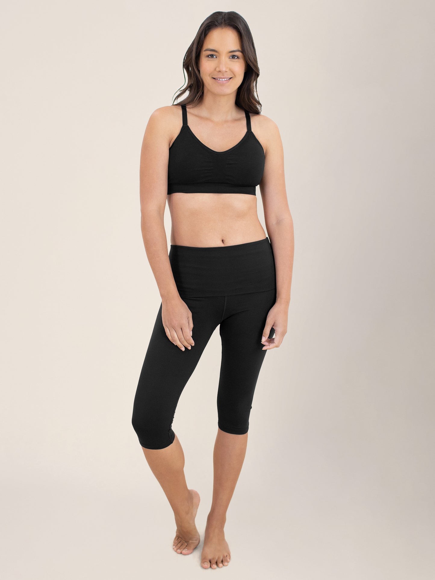 Model standing with her weight more on one leg with her hands at her sides wearing the Diana Sublime® Sports Bra in Black@model_info:Cristy is wearing a Small.