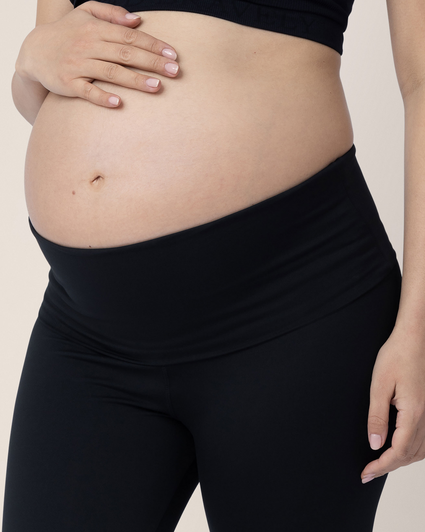Closeup of a pregnant model wearing the Louisa Maternity & Postpartum Legging in Black, classic.