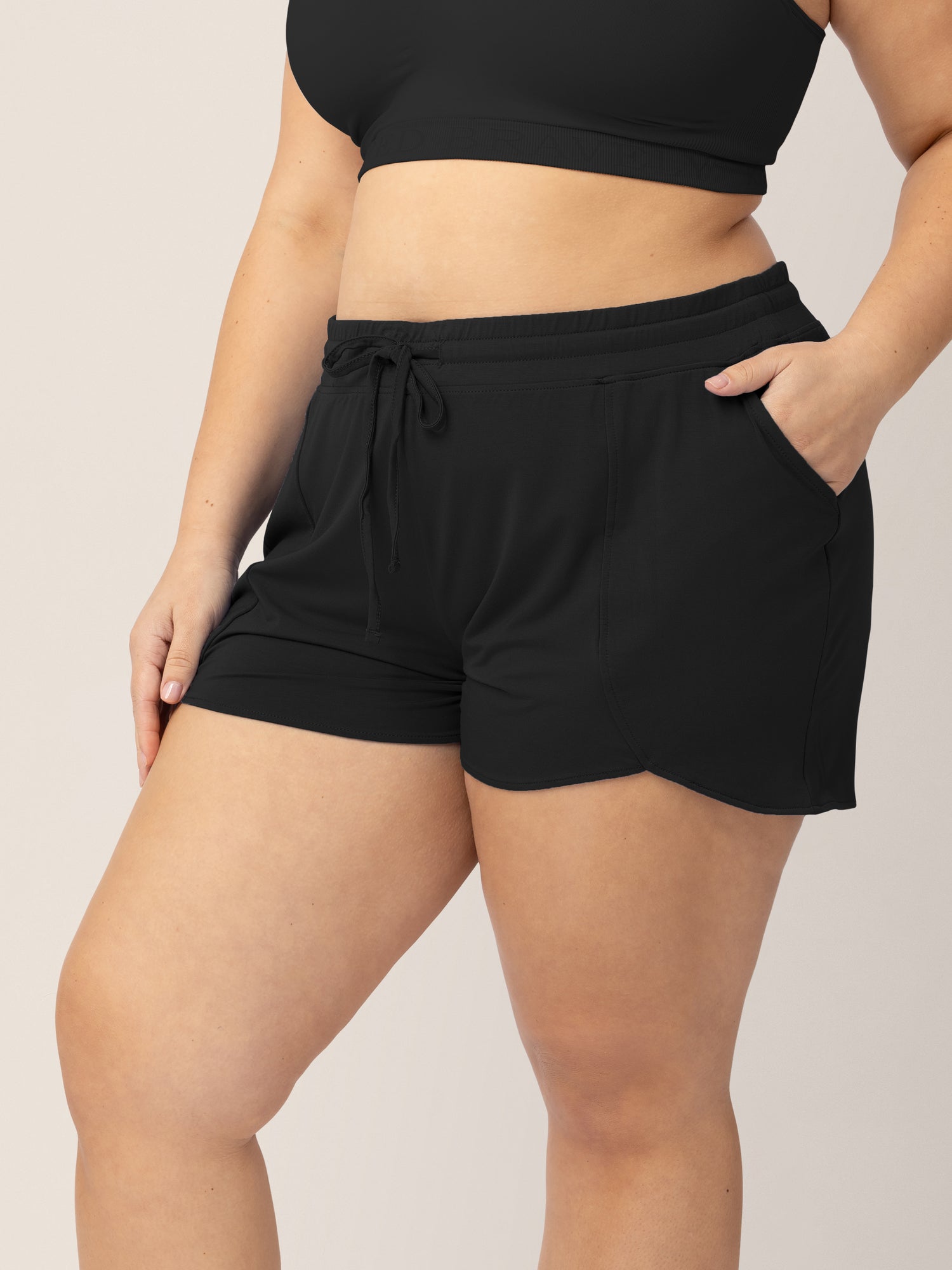 Closeup of a model wearing the Bamboo Maternity & Postpartum Lounge Short in Black @model_info:Venezia is wearing a 1X.