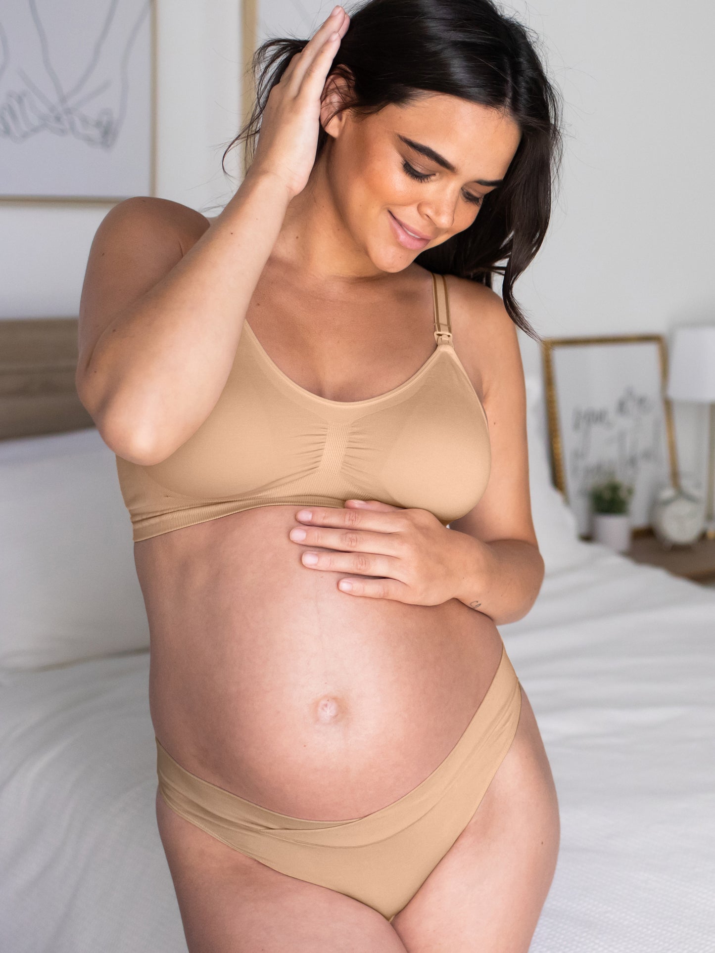 Front view of a pregnant model wearing the Bamboo Maternity & Postpartum Thong in Beige