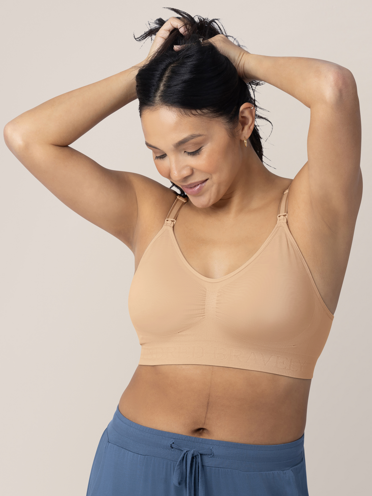 Model wearing the Simply Sublime® Nursing Bra in Beige with her hands in her hair. @model_info:Julana is wearing a Small.