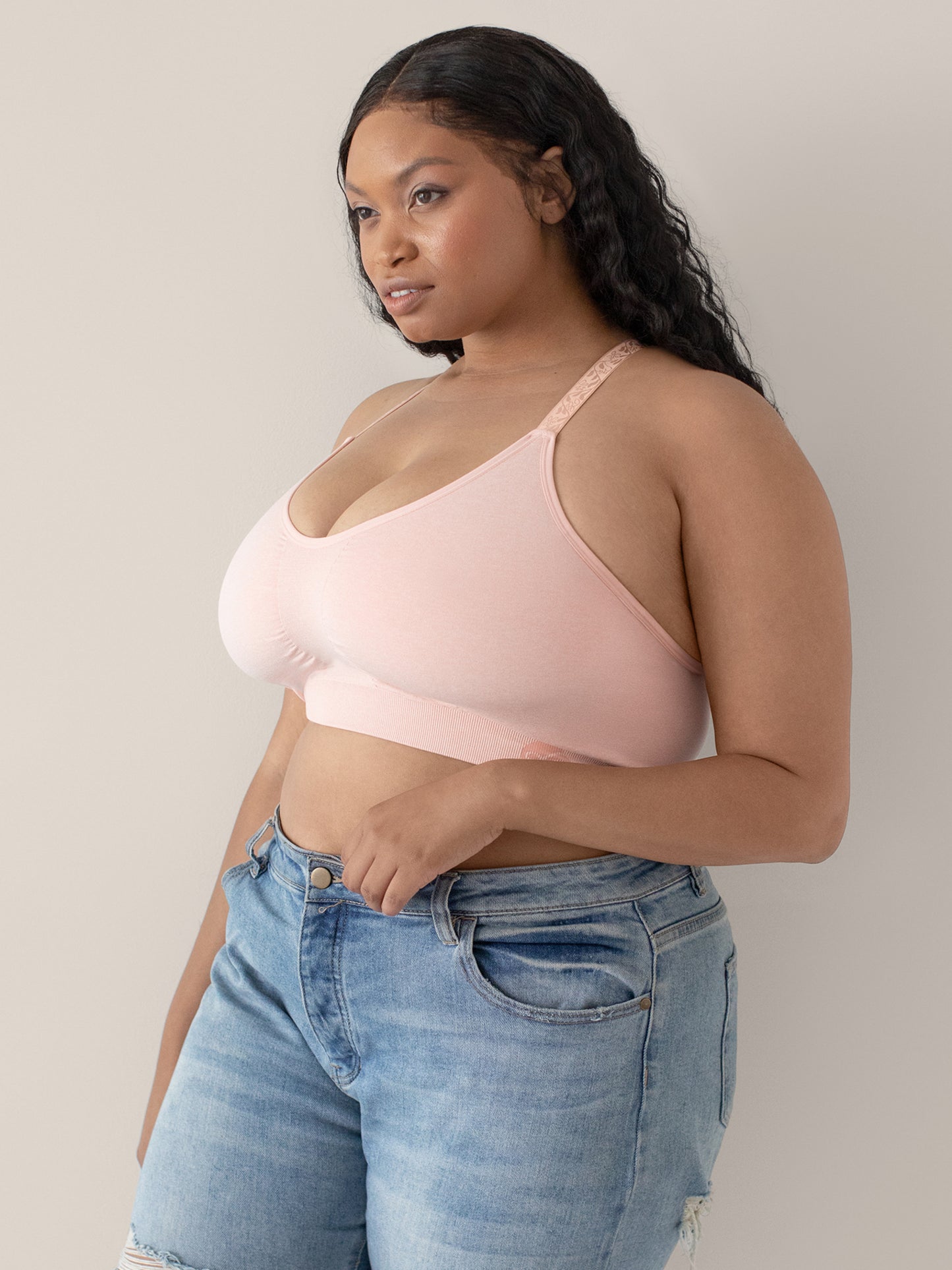 Three-quarters view of a model wearing the Diana Sublime® Sports Bra in Pink Heather