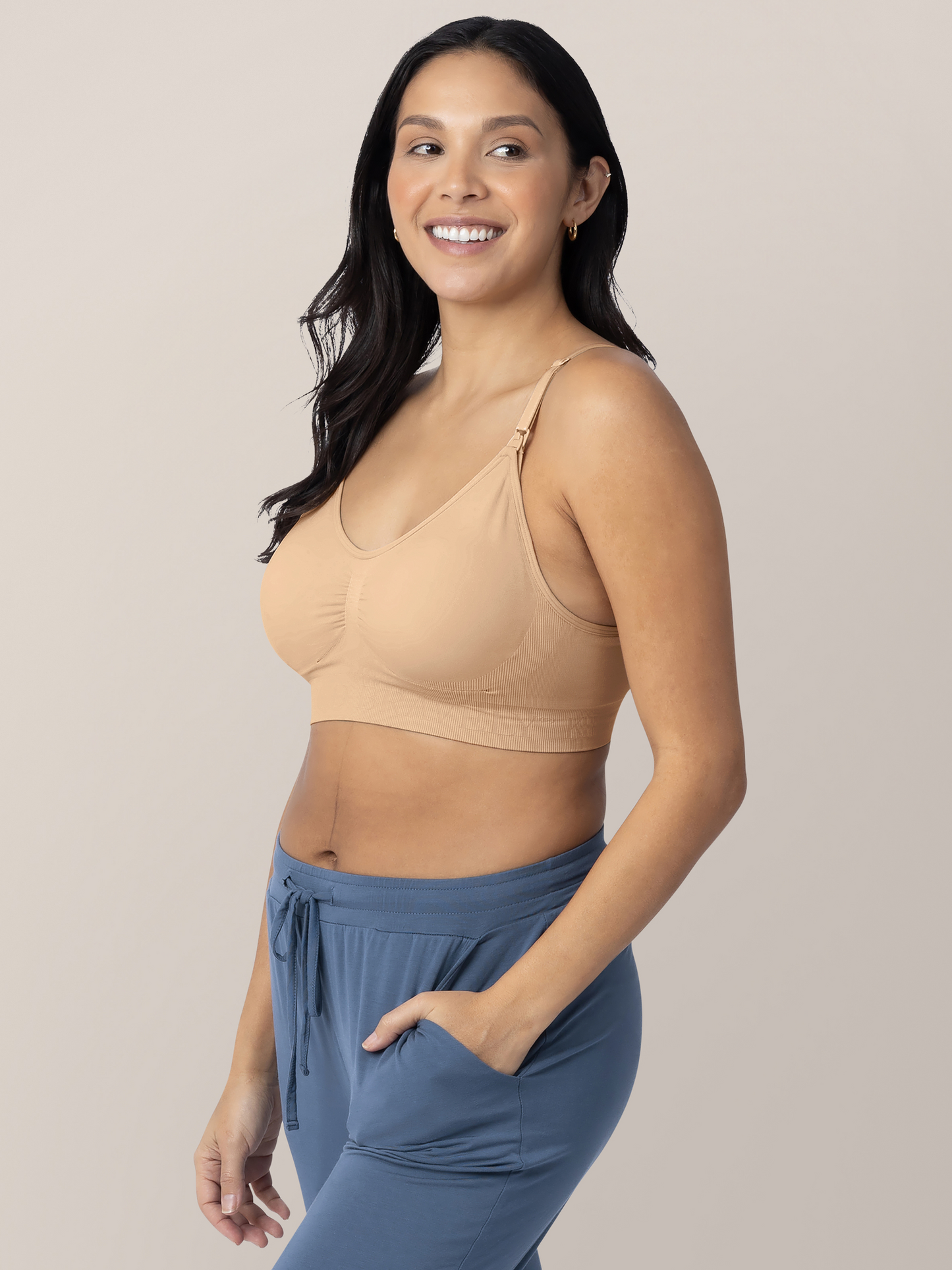 Model wearing the Simply Sublime® Nursing Bra in Beige with her hand in her pocket.