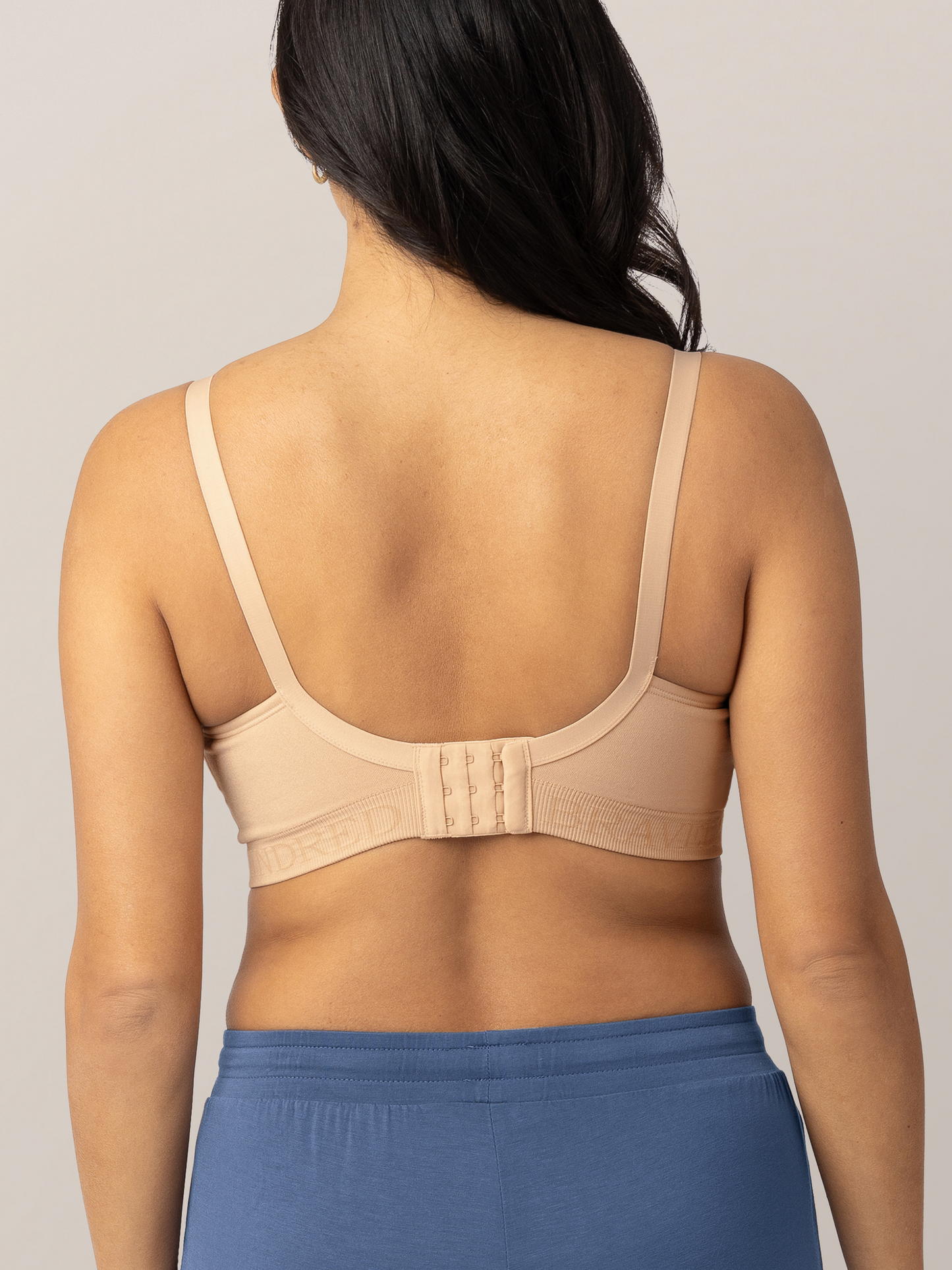 Back of a model wearing the Signature Sublime® Contour Maternity & Nursing Bra in Beige