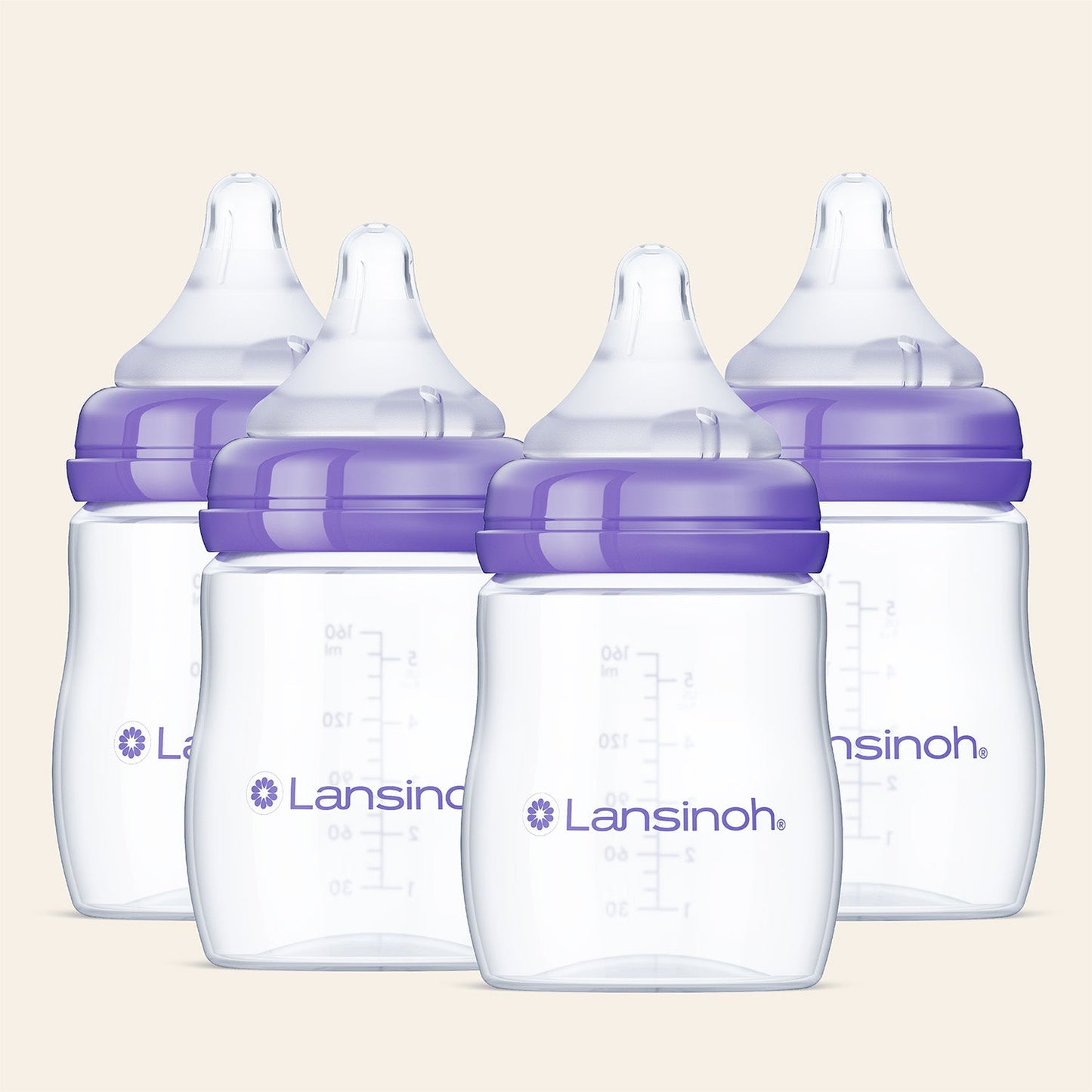 Four Lansinoh baby bottles with purple caps on a beige background
