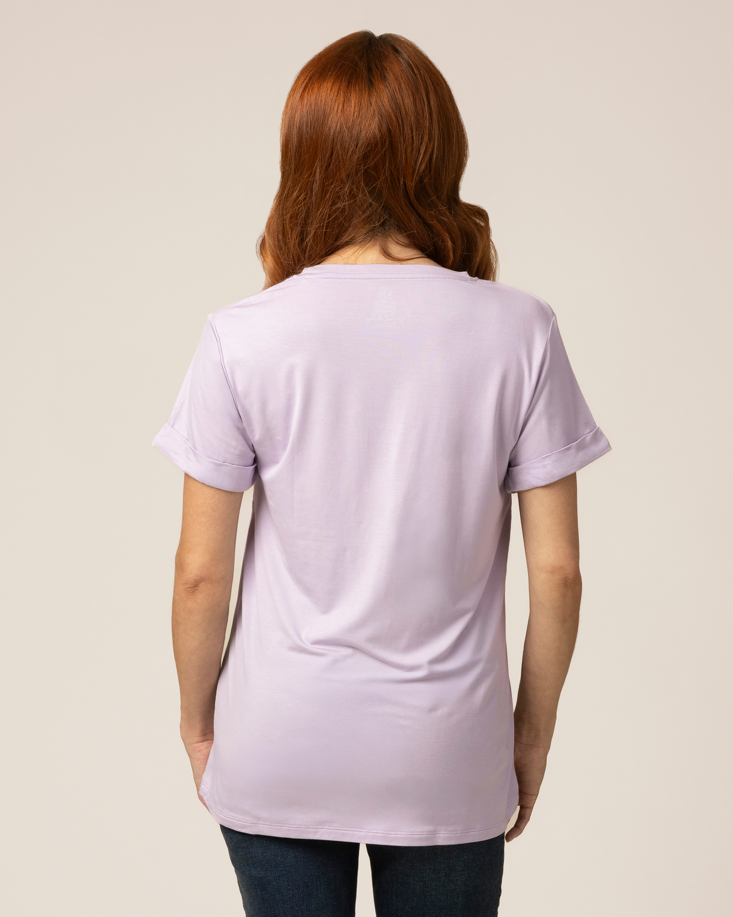 Back view of model wearing the Everyday Asymmetrical Nursing T-shirt in Lavender Mist