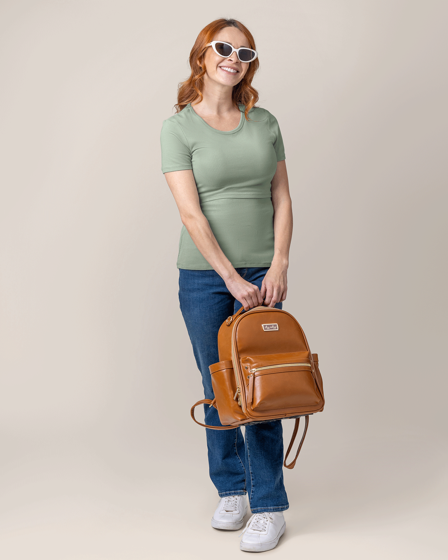 Front view of model wearing Ribbed Bamboo Crew Neck Nursing T-shirt in Aqua Mist, holding diaper baby