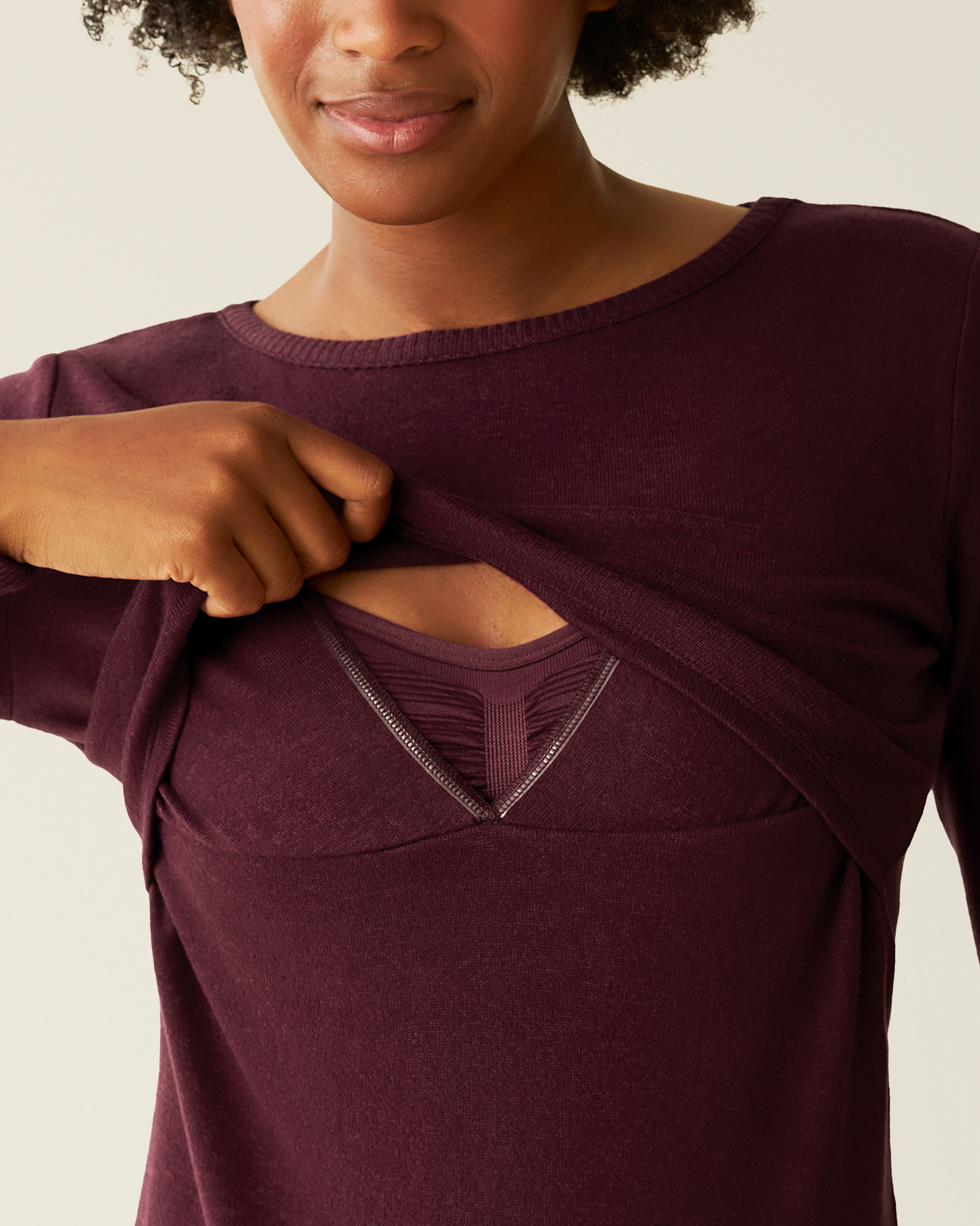 Person showing nursing functionality on CozyKnit Nursing Pajama & Lounge Set in Deep Burgundy on a neutral background