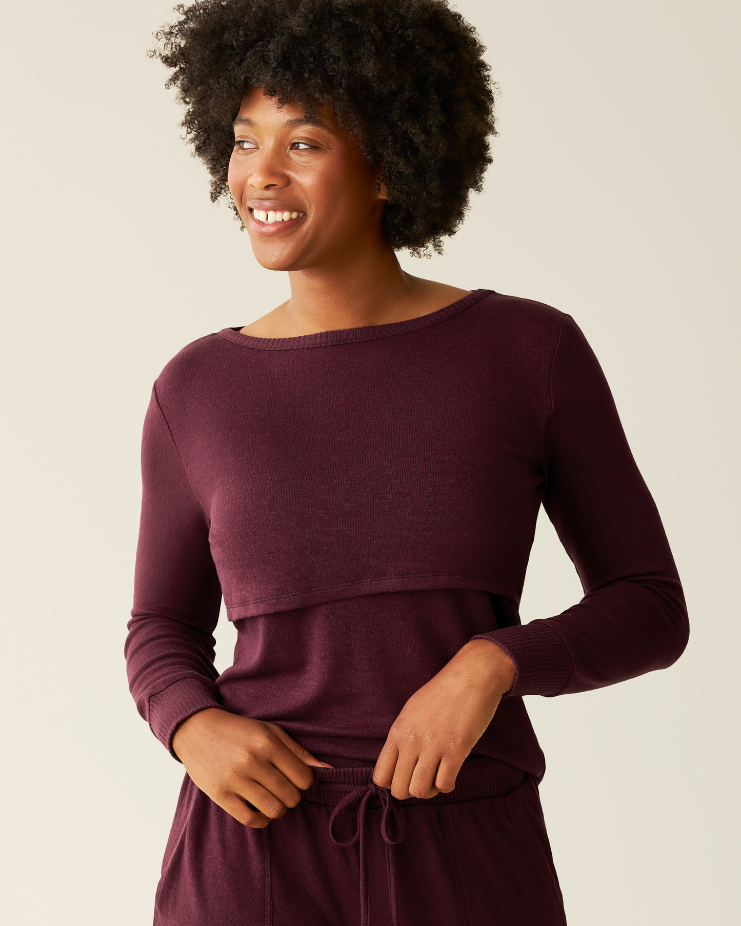 Woman wearing a CozyKnit Nursing Pajama & Lounge Set in Deep Burgundy against a plain background