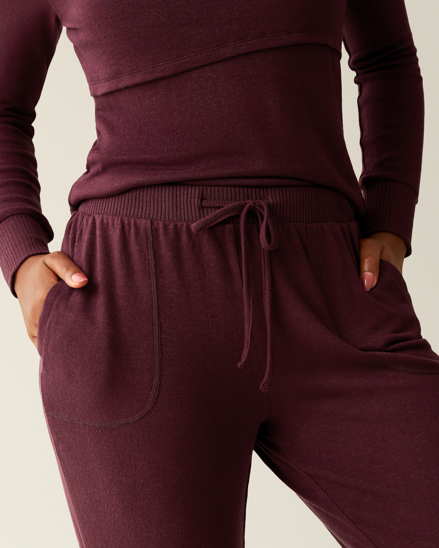 Model wearing CozyKnit Nursing Pajama & Lounge Set in Deep Burgundy with a drawstring waist on a neutral background