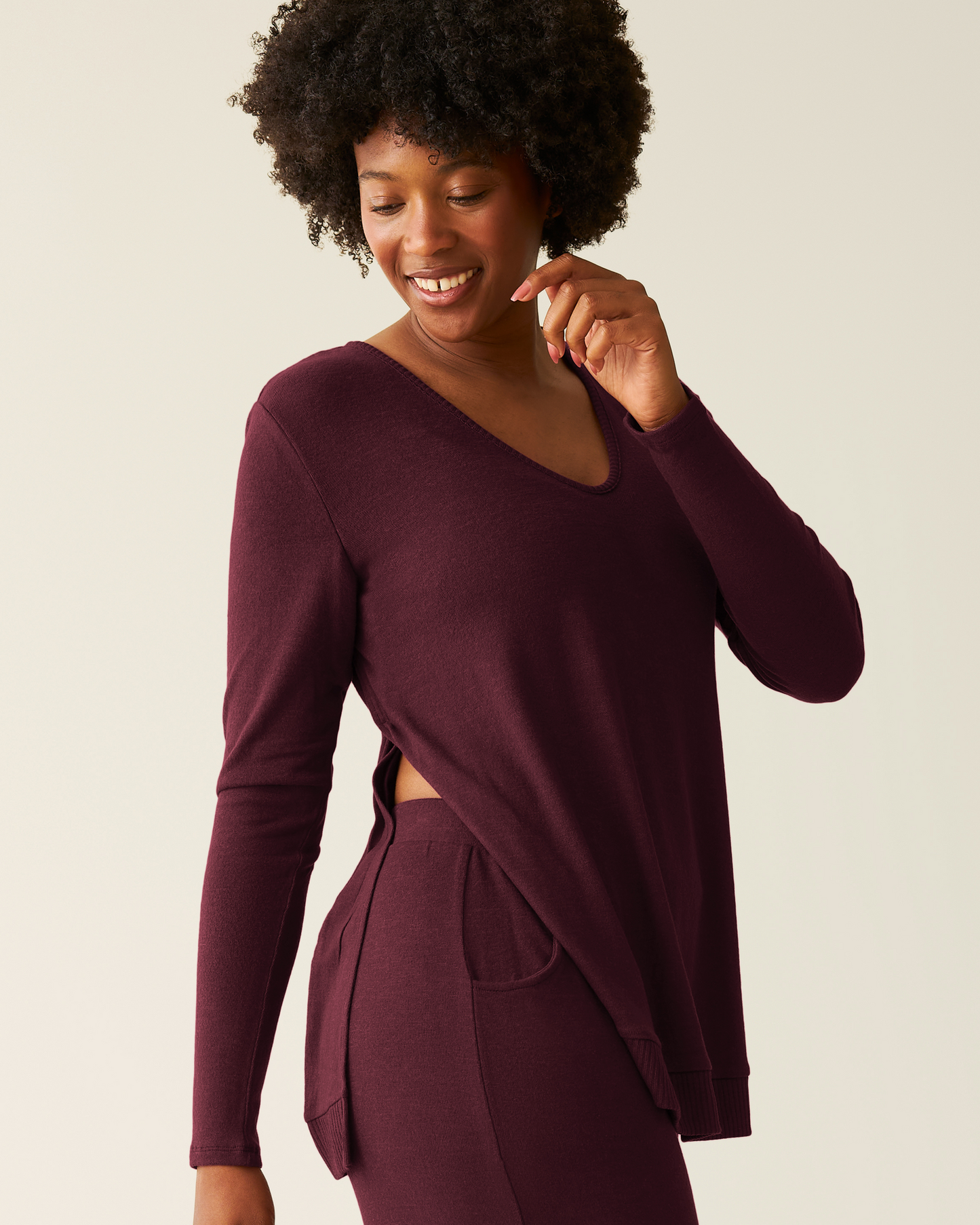 Woman wearing CozyKnit Maternity & Nursing V-neck Top in Deep Burgundy with matching pants on a plain background