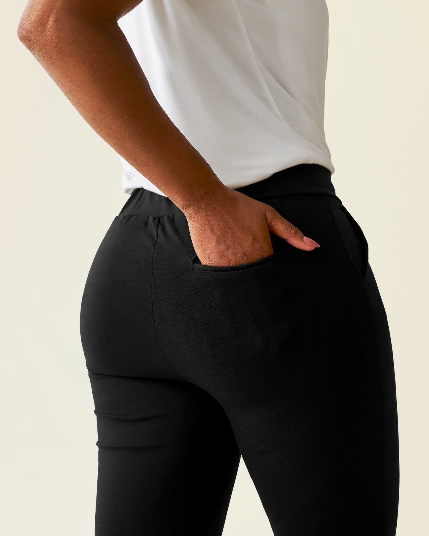 Woman wearing a Ponte Pant with a white top, showing back pocket