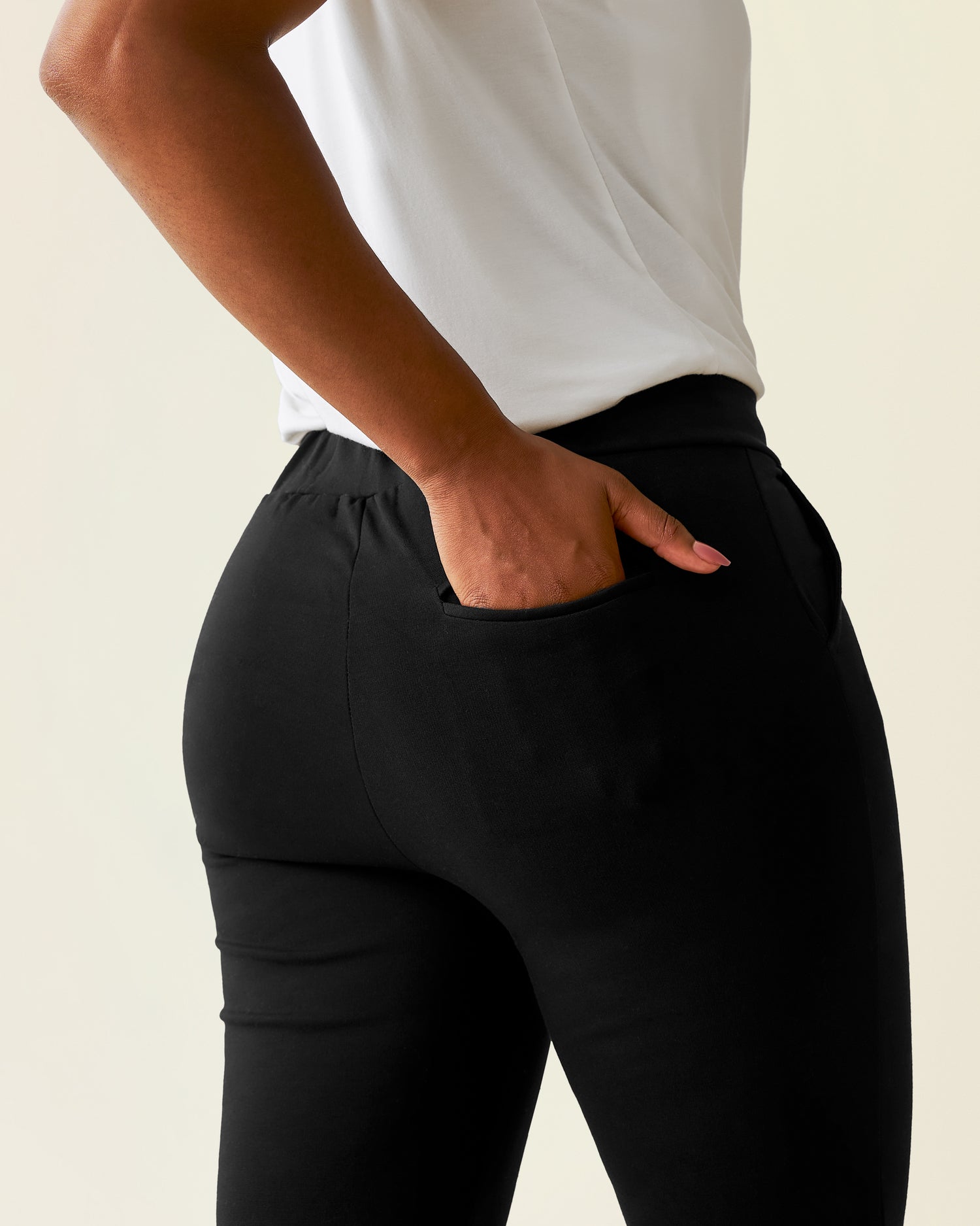 Woman wearing a Ponte Pant with a white top, showing back pocket