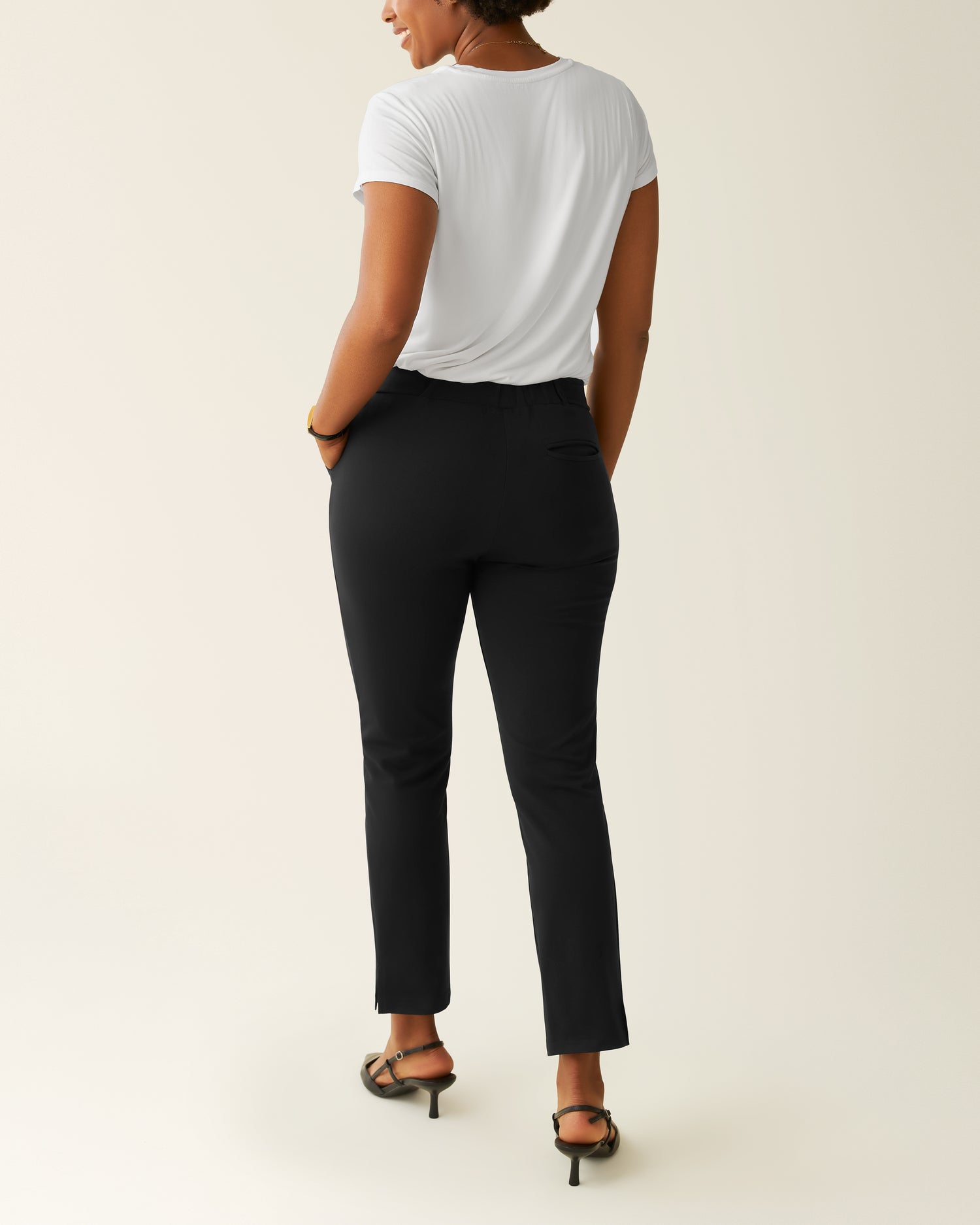 Woman wearing the Ponte Straight Leg Pant with a white top, showing back of pants