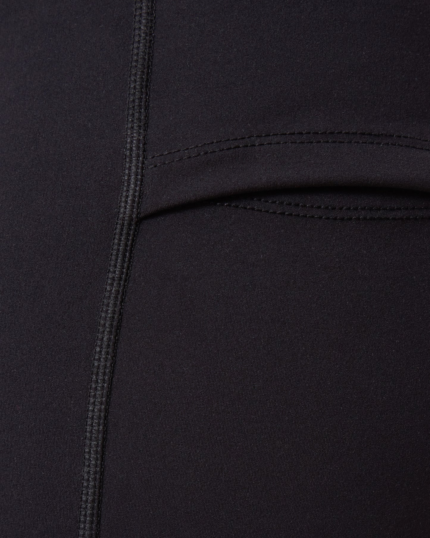 Close-up of a Stevie Active Postpartum Bike Short in black with a pocket detail