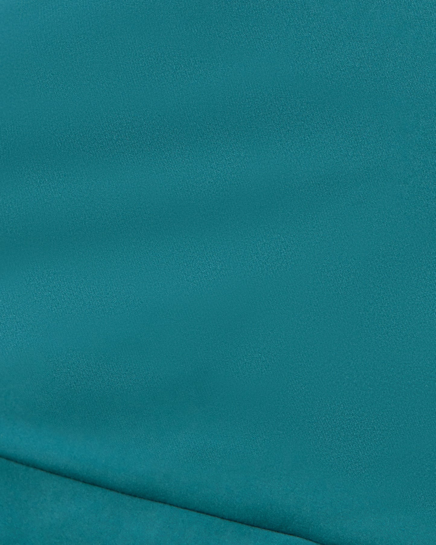 Teal fabric texture with a seam