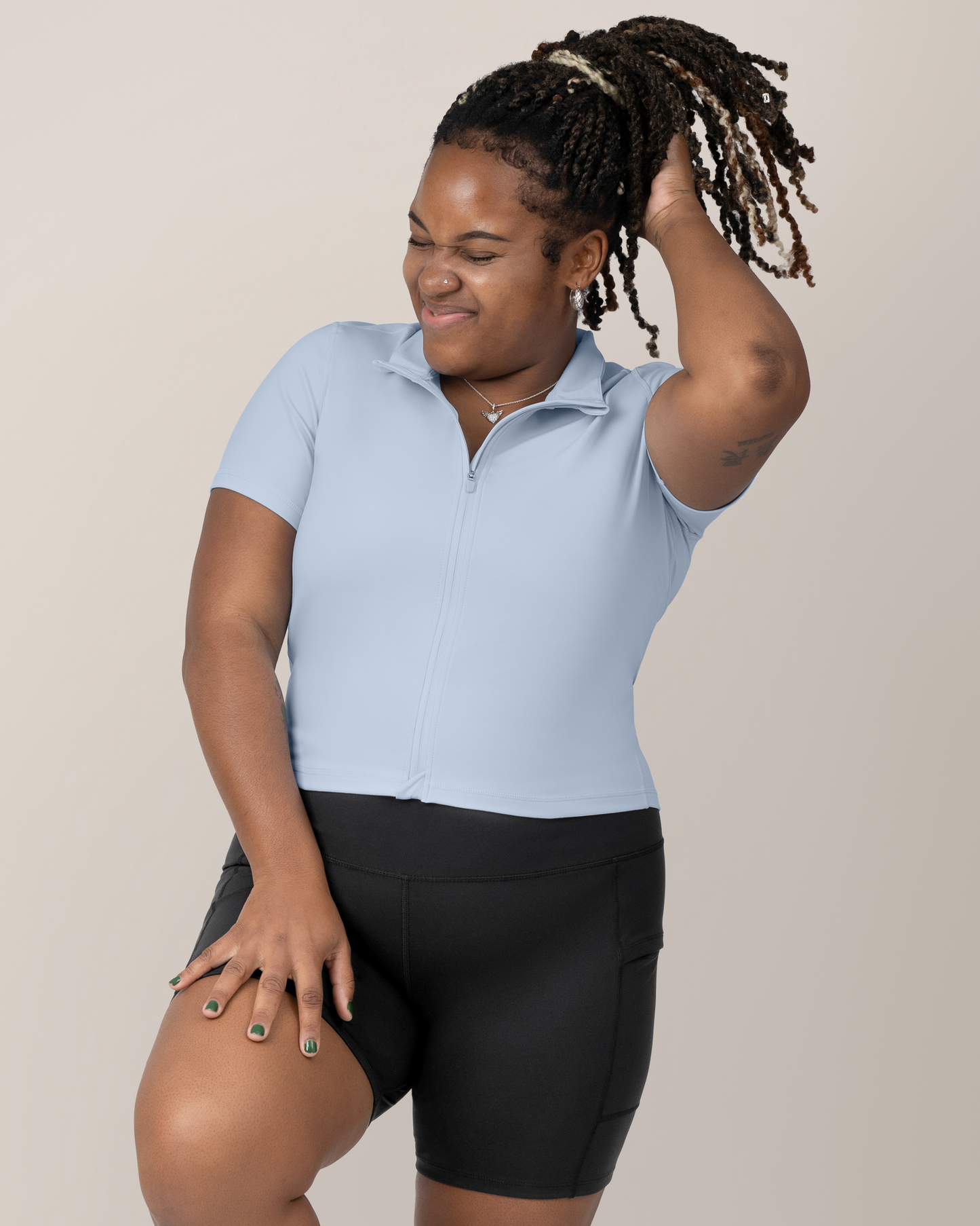 Front view of Model wearing the Presley Active Zip Front Nursing Top in Light Blue @model_info:Tonia is wearing a Large.