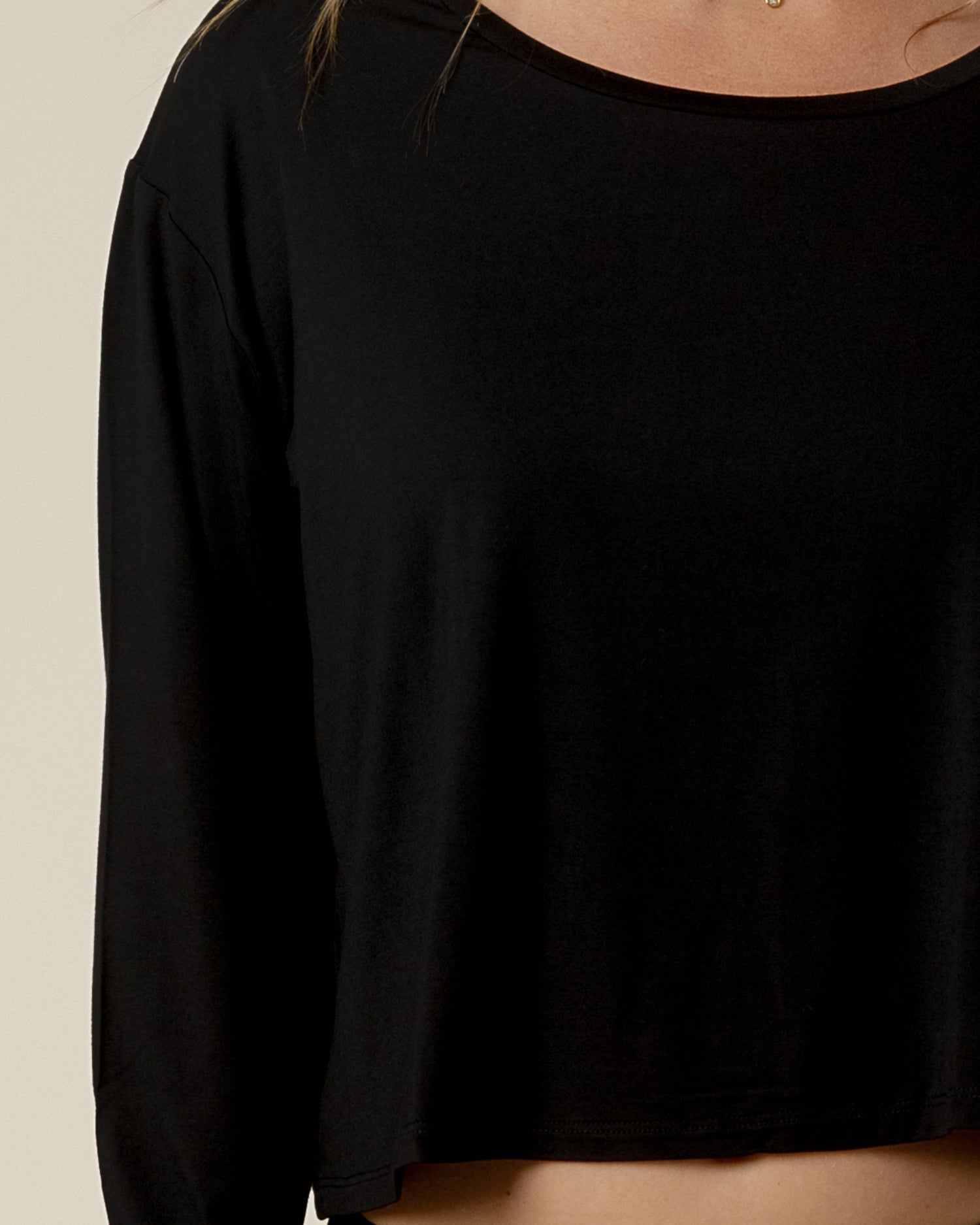 Close up view of model wearing the Aria Bamboo Casual Cropped Long Sleeve Top in Black
