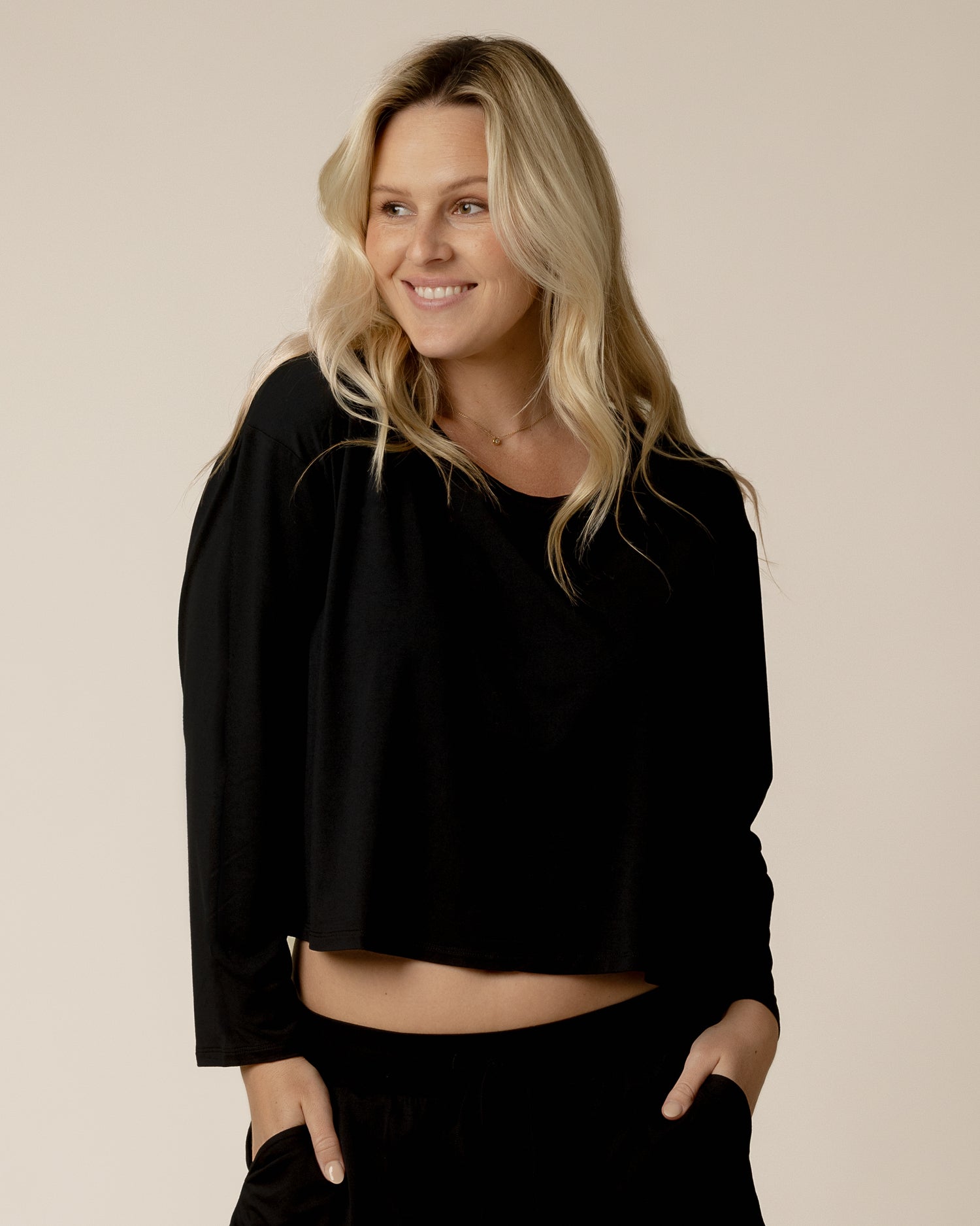 Front view of model wearing the Aria Bamboo Casual Cropped Long Sleeve Top in Black @model_info:Maddy is wearing a Small