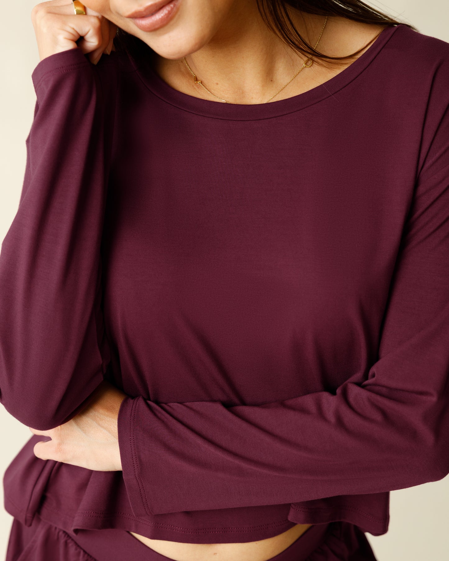 Woman wearing the Aria Bamboo Casual Cropped Long Sleeve Top in Deep Burgundy, showing neckline and fabric detail