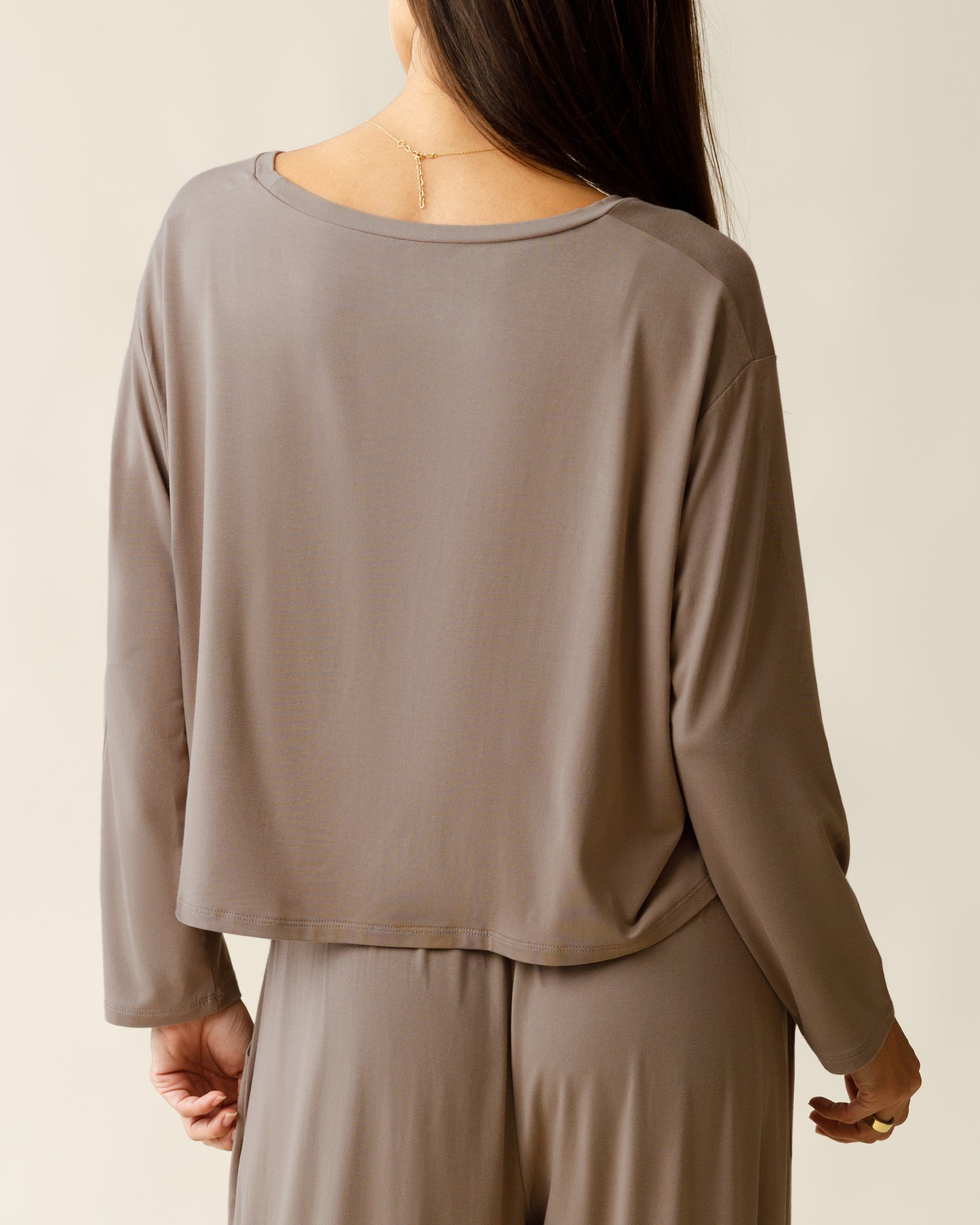 Woman wearing the Aria Bamboo Casual Cropped Long Sleeve Top with matching bottoms, showing top from the back