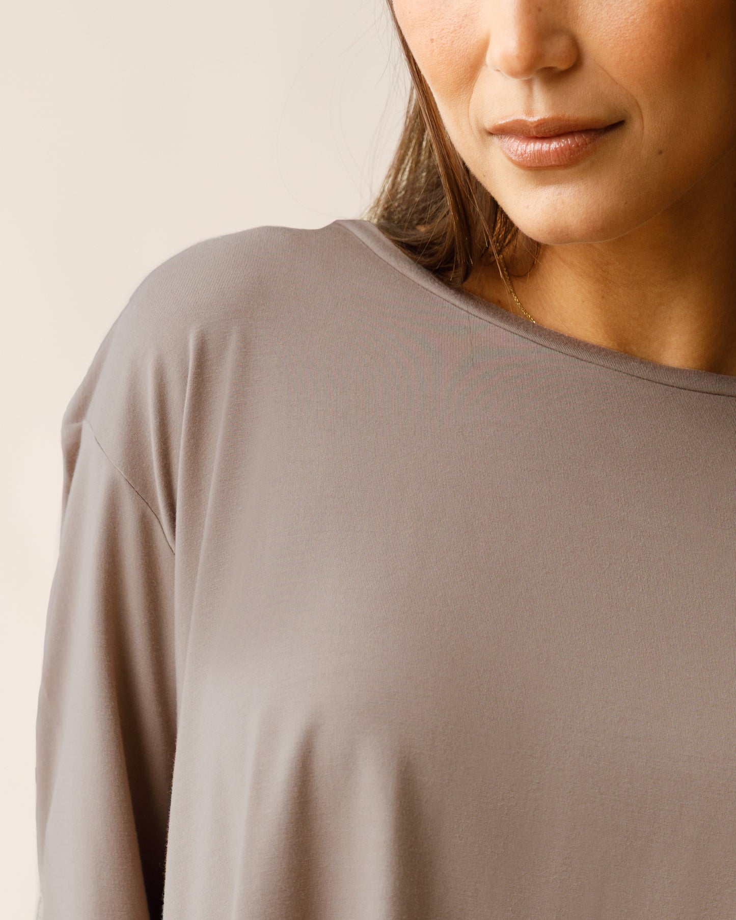 Woman wearing the Aria Bamboo Casual Cropped Long Sleeve Top in Taupe, showing detail of neckline and fabric