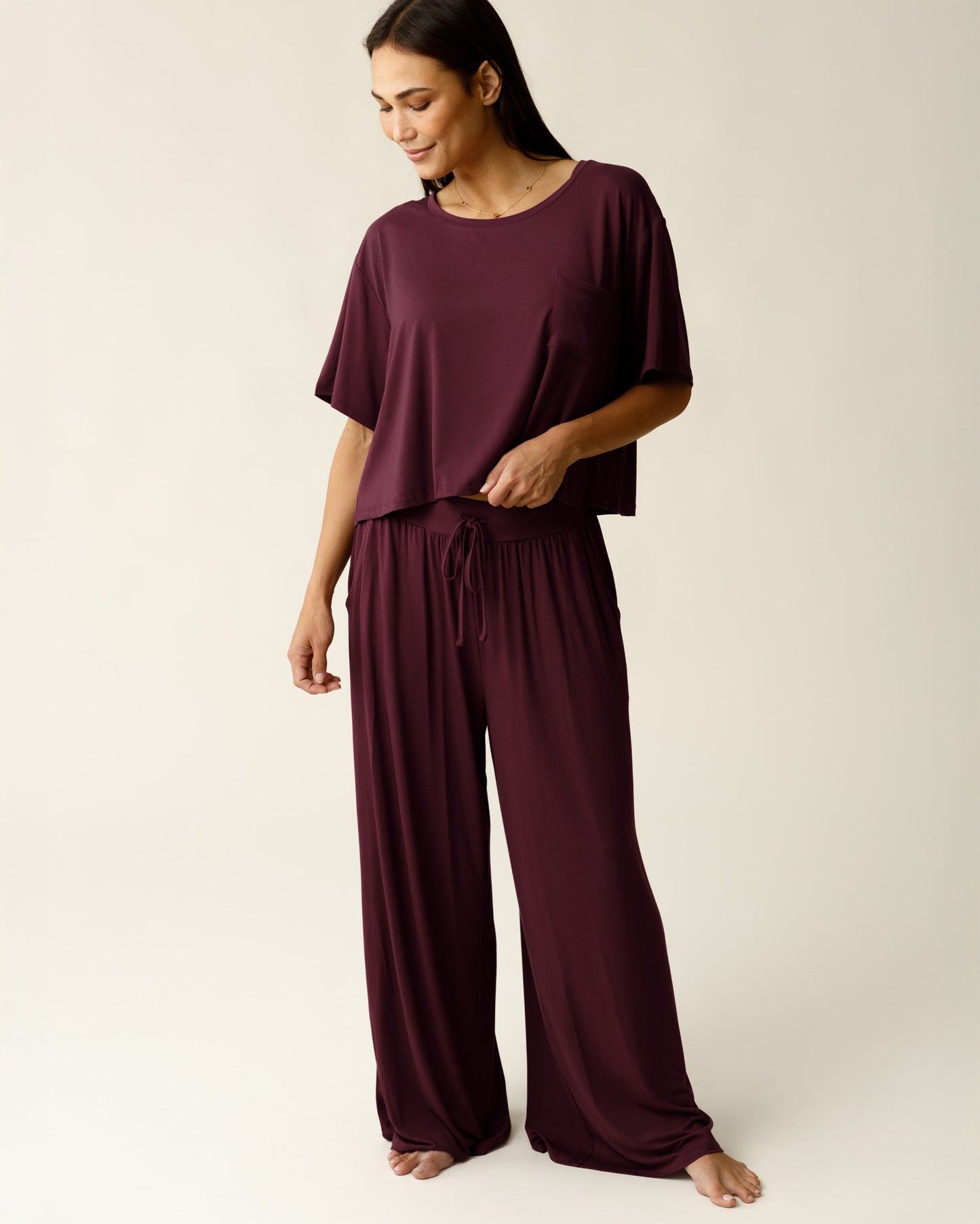 Woman wearing the Aria Bamboo Casual Lounge Pant in Deep Burgundy, paired with matching Aria Bamboo Casual Cropped Short Sleeve Top@model_info:Lisa is 5'6" and wearing a Small.
