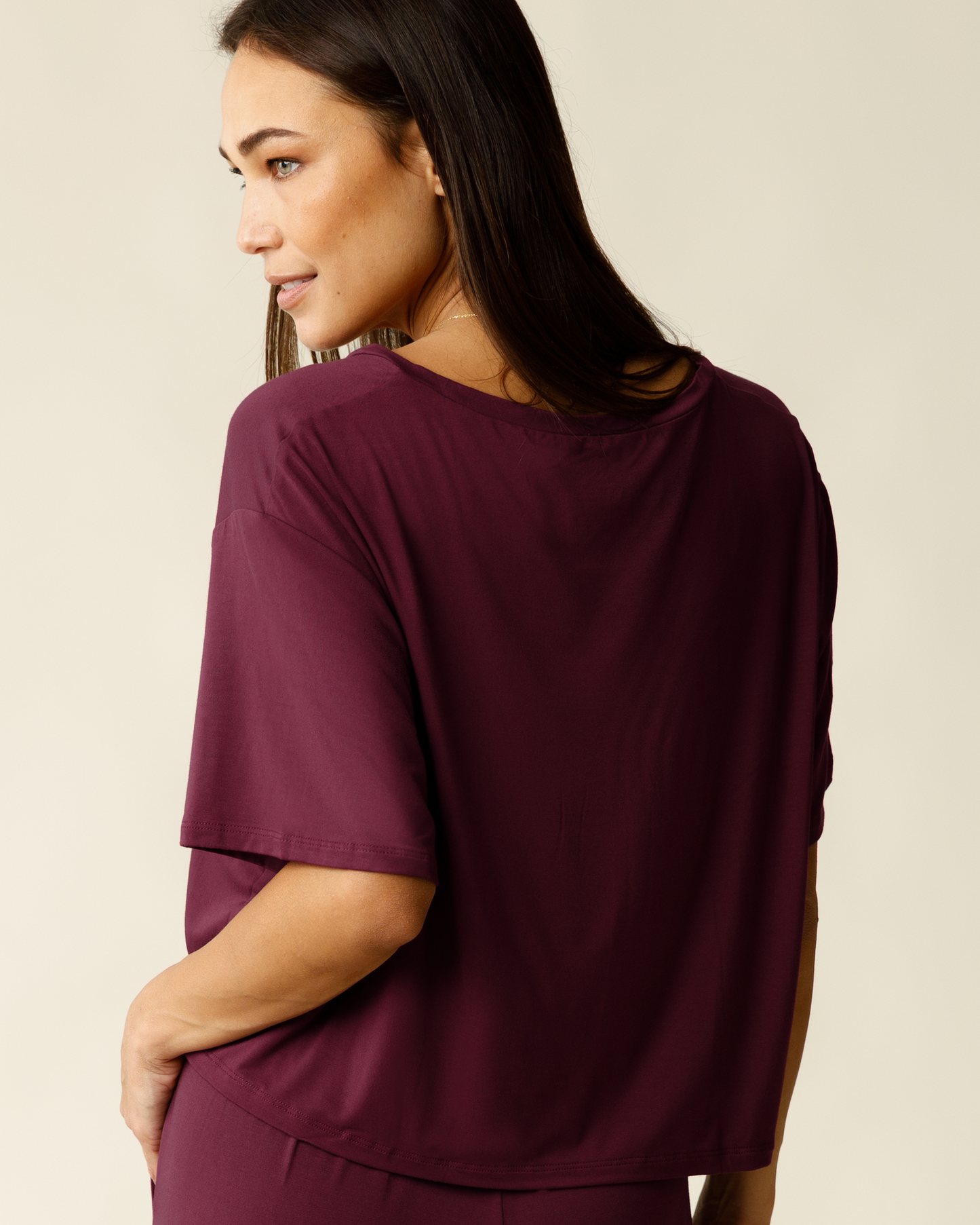 Back view of woman wearing the Aria Bamboo Casual Cropped Short Sleeve Top in Deep Burgundy