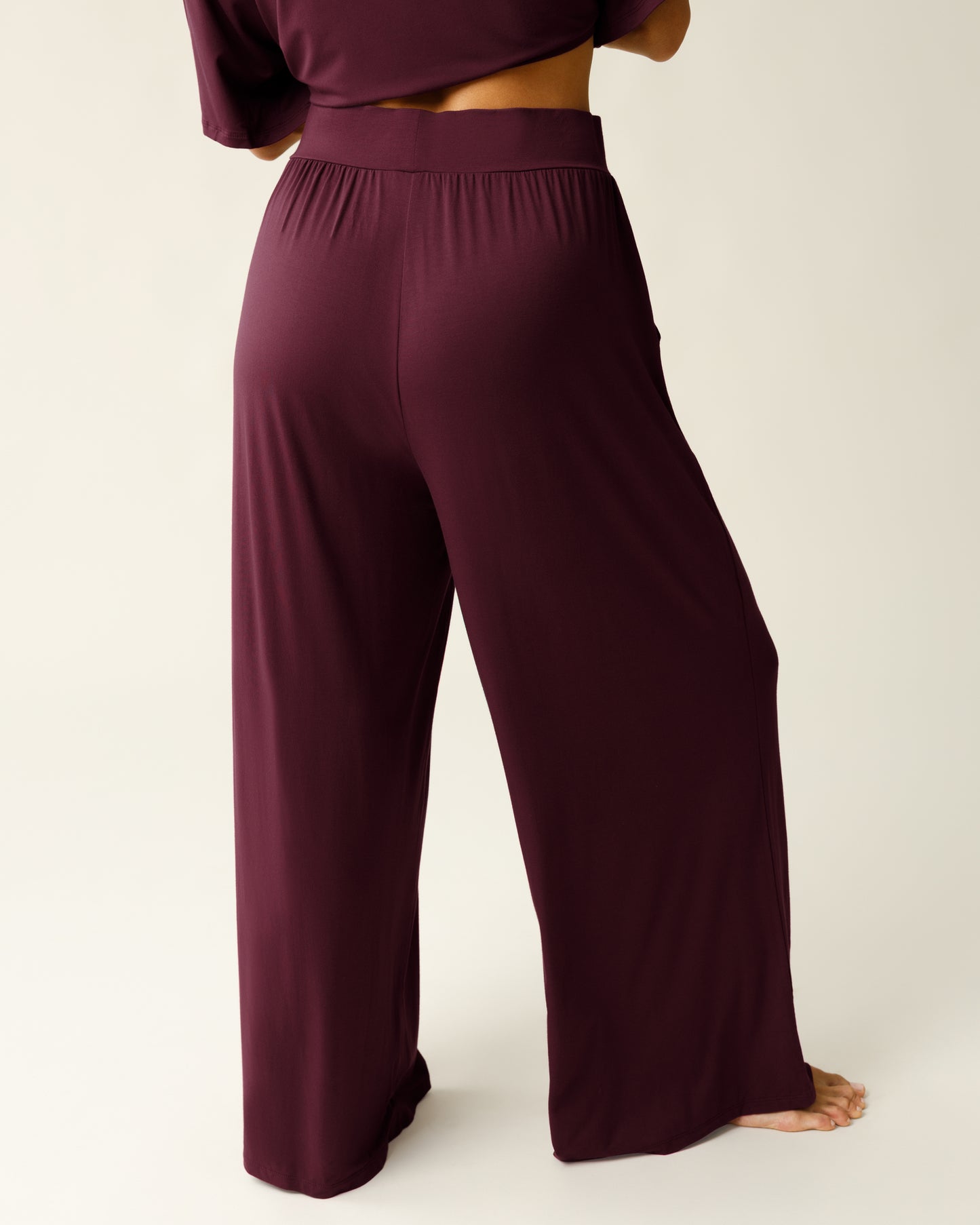 Woman wearing the Aria Bamboo Casual Lounge Pant in Deep Burgundy, showing waist down from the back