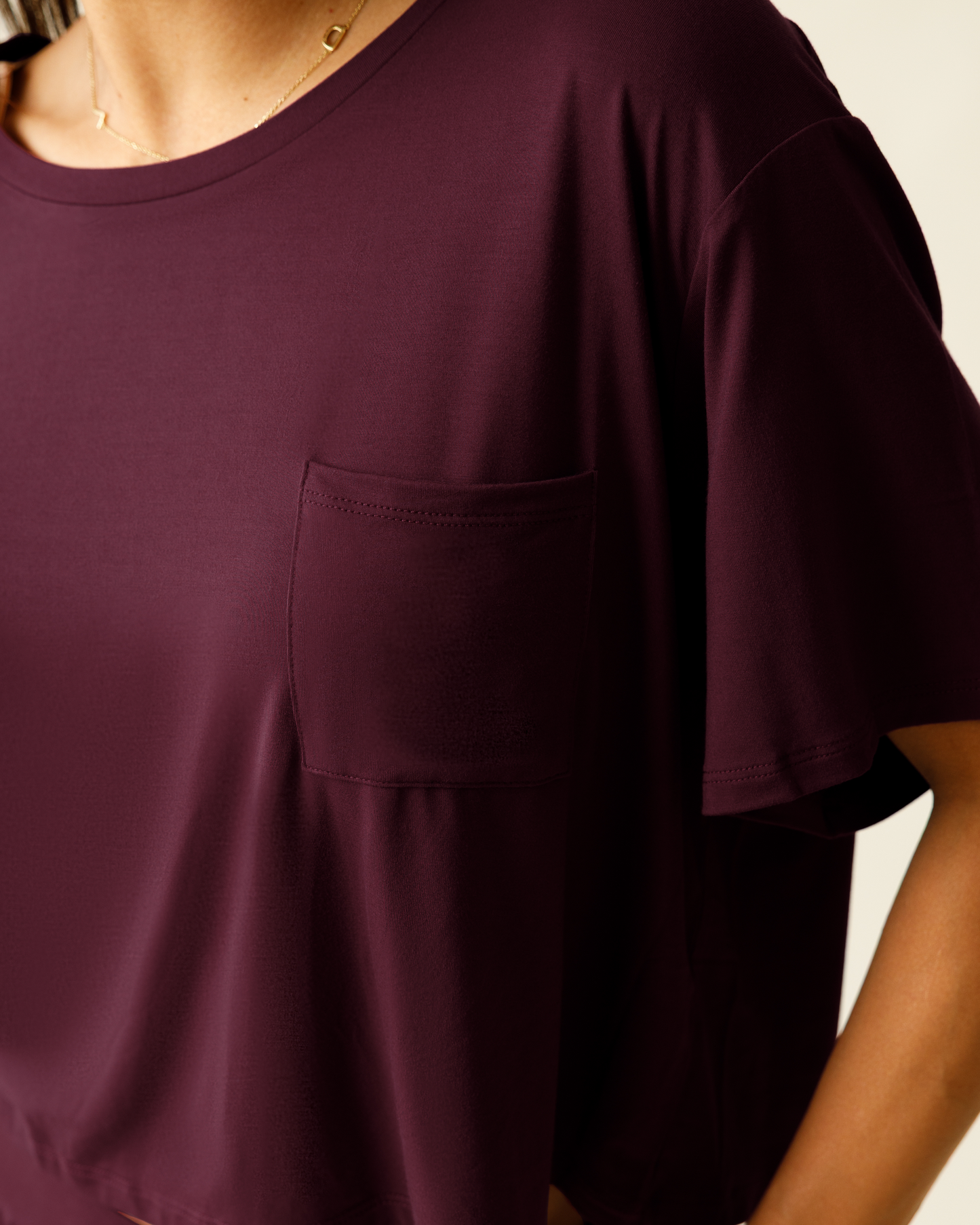Close up of woman wearing the Aria Bamboo Casual Cropped Short Sleeve Top in Deep Burgundy, showing neckline and pocket detail
