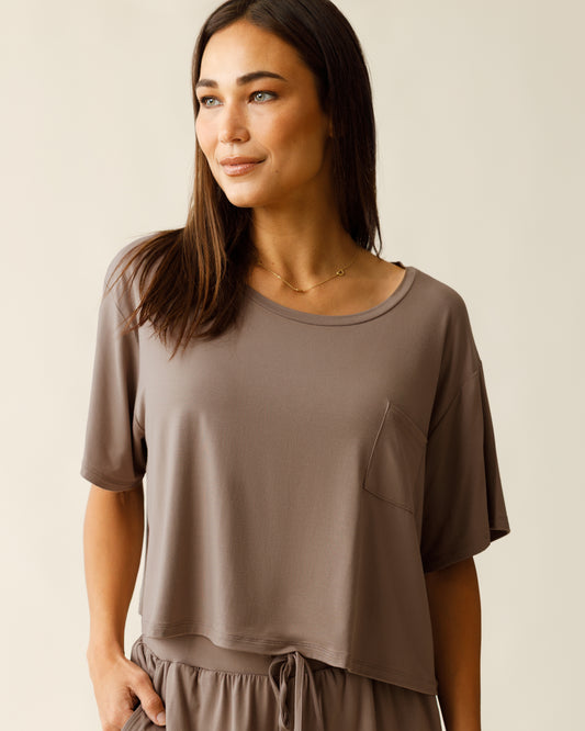 Woman wearing the Aria Bamboo Casual Cropped Short Sleeve Top in Taupe@model_info:Lisa is wearing a Small.