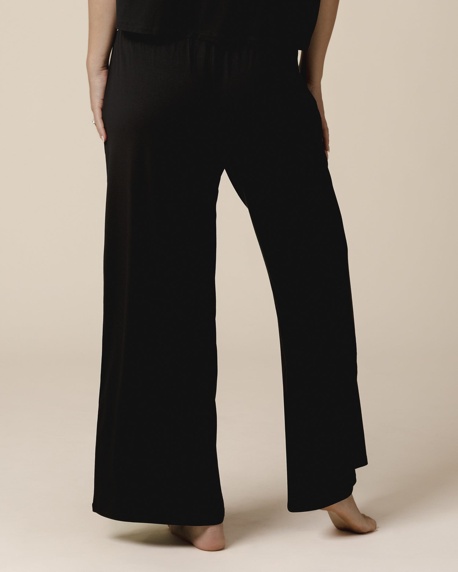 Back cropped in view of model wearing the Aria Bamboo Casual Lounge Pant in Black