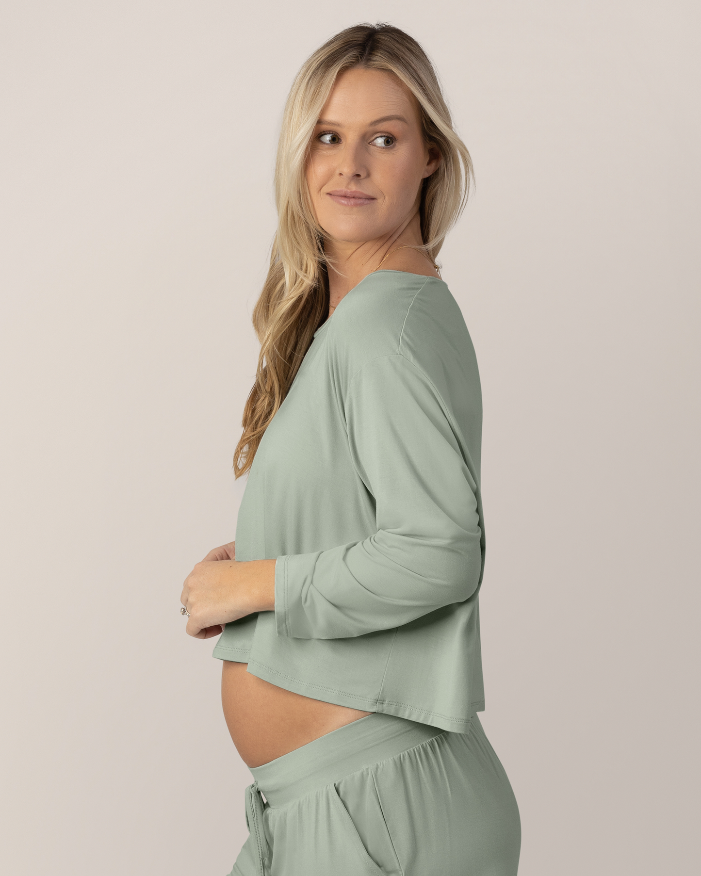 Side view of model wearing the Aria Bamboo Casual Cropped Long Sleeve Top in Aqua Mist