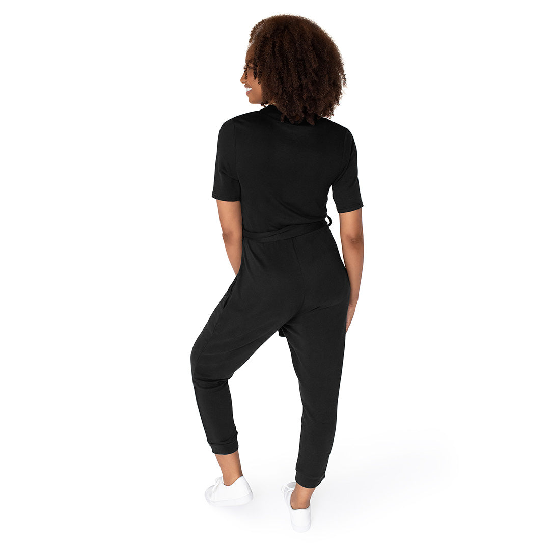 Back of a model wearing the Around the Clock Nursing Jumpsuit in Black